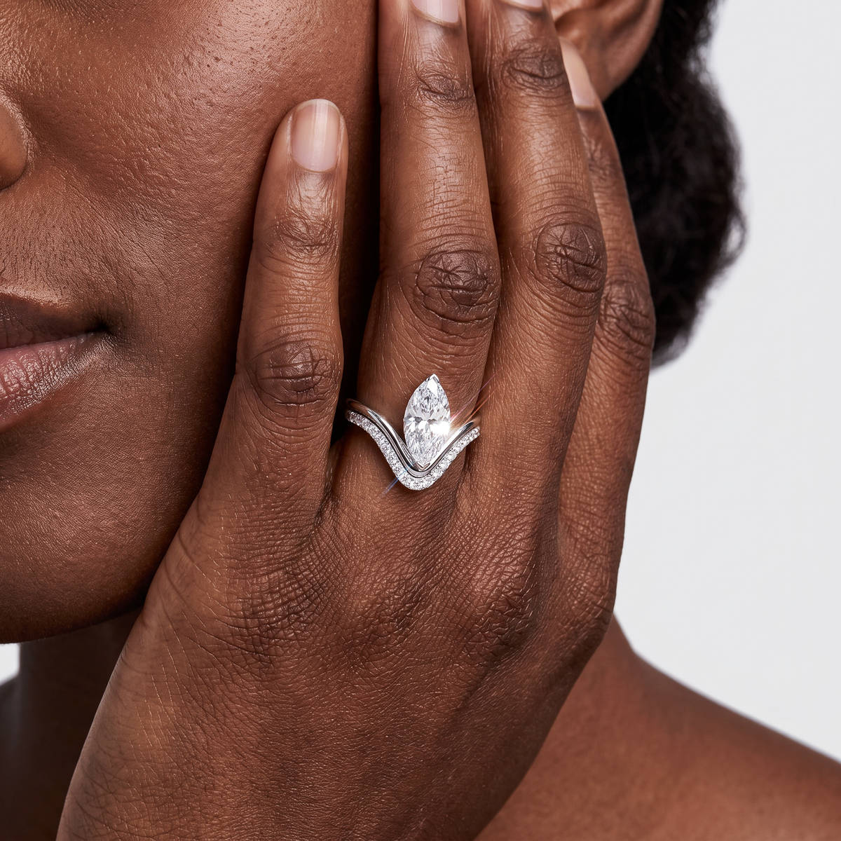 Model wearing a marquise lab-grown diamond two-piece ring set in white gold.