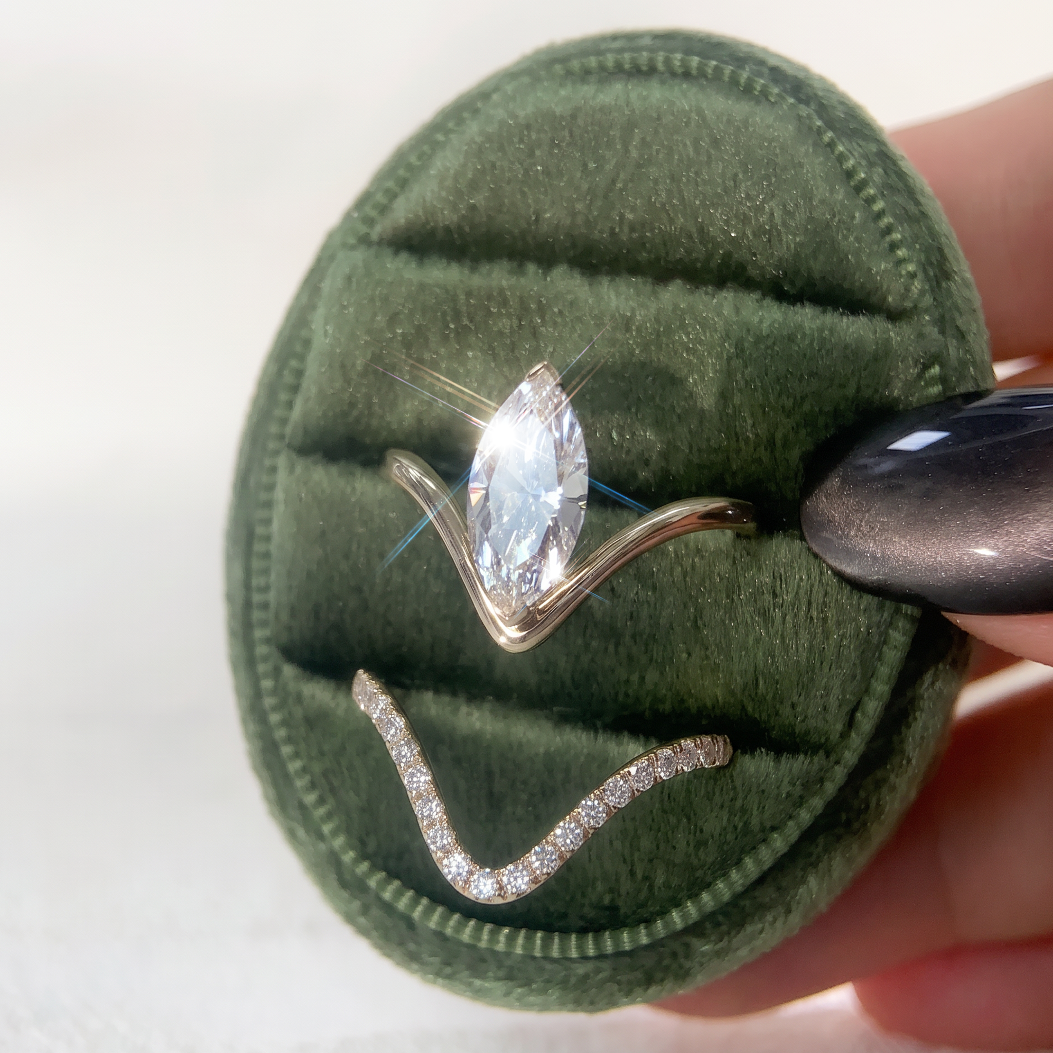 Marquise lab-grown diamond two-piece ring set in white gold styled on hand.