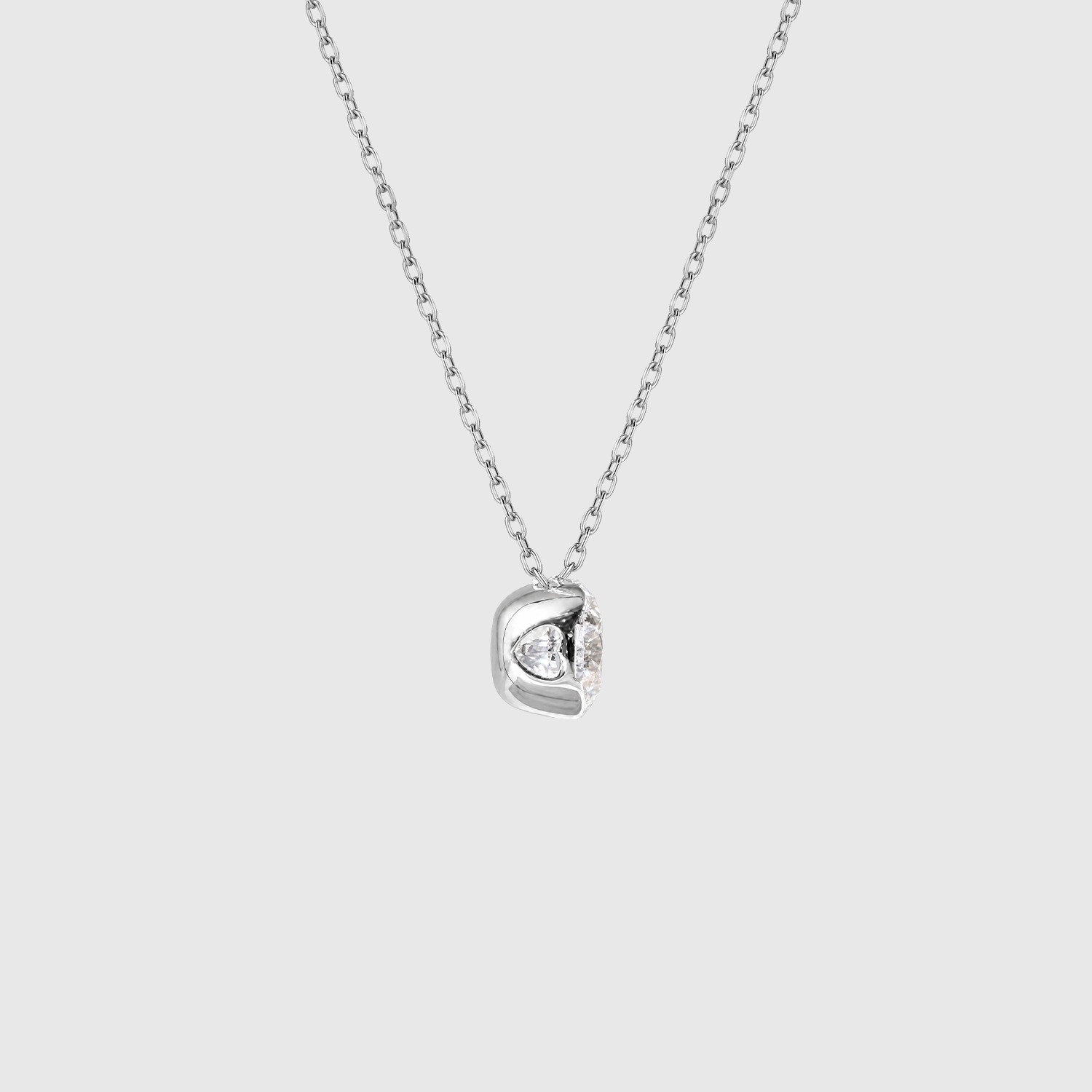 White gold round diamond solitaire necklace setting detail.