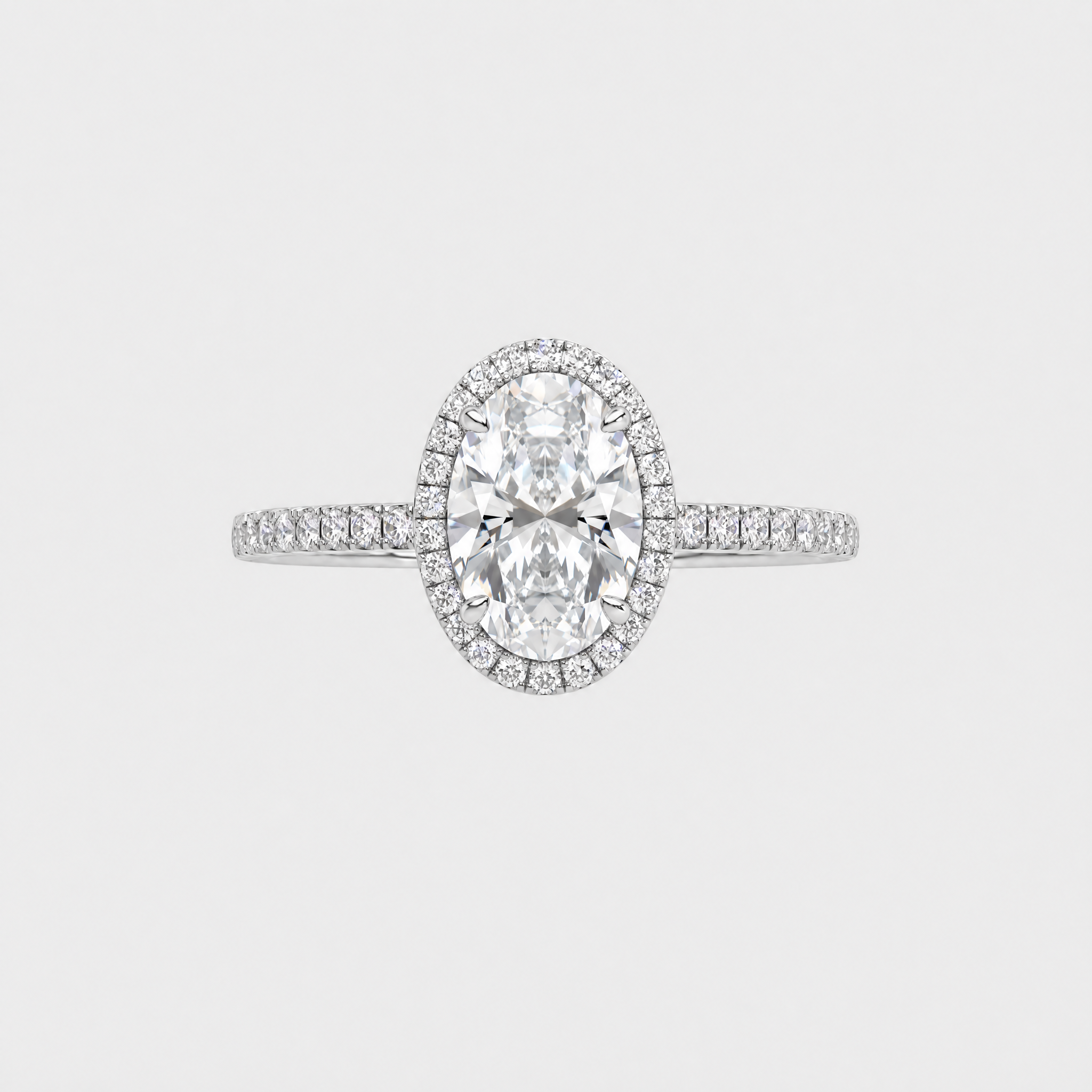 Front view of an oval-cut center stone engagement ring with a halo and white-metal pavé band.