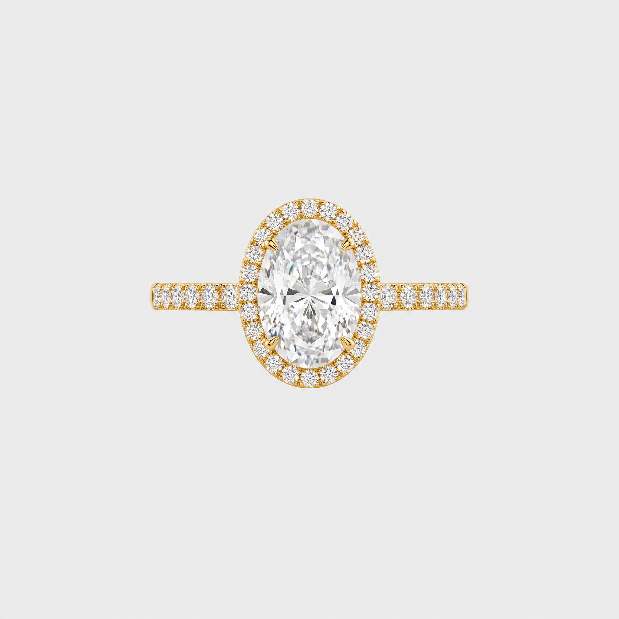 Front view of an oval-cut center stone engagement ring with a halo and yellow gold pavé band.