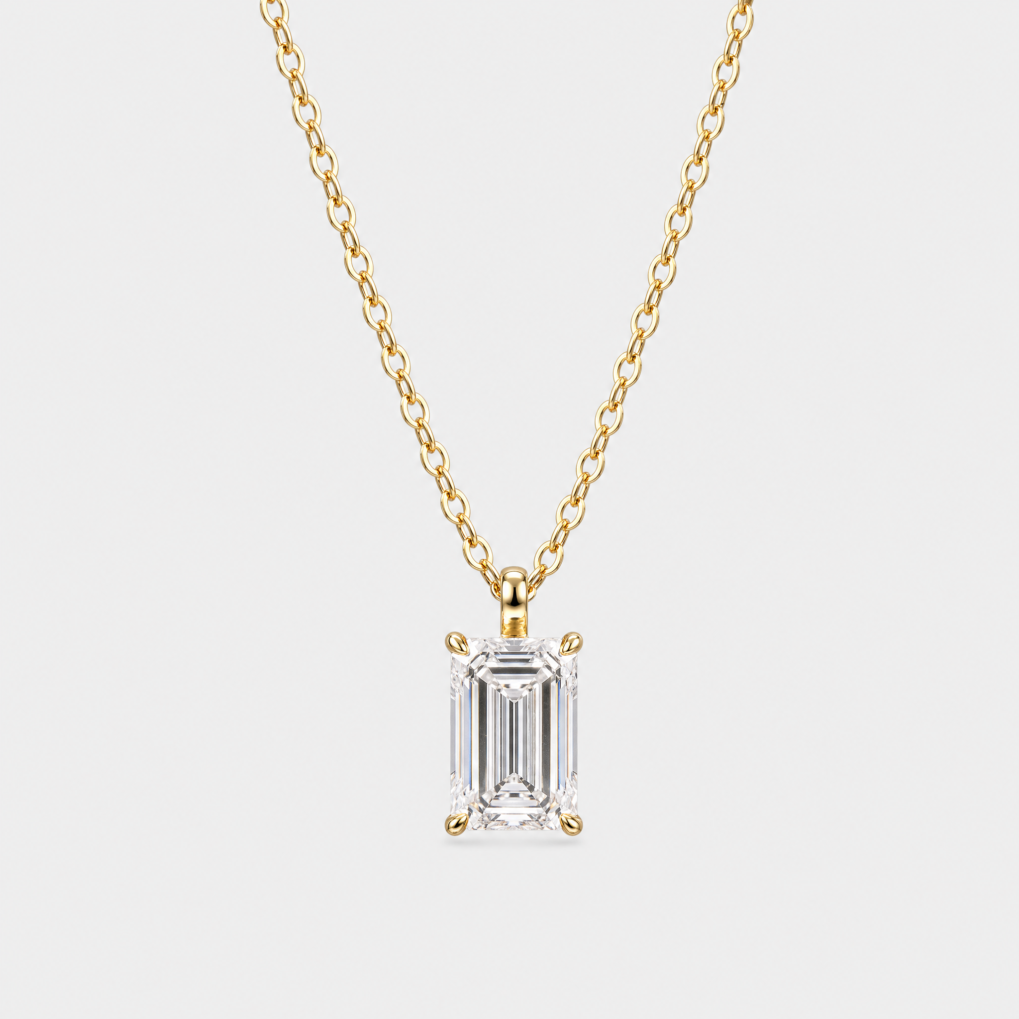Emerald-cut solitaire pendant in yellow gold displayed on a matching chain.