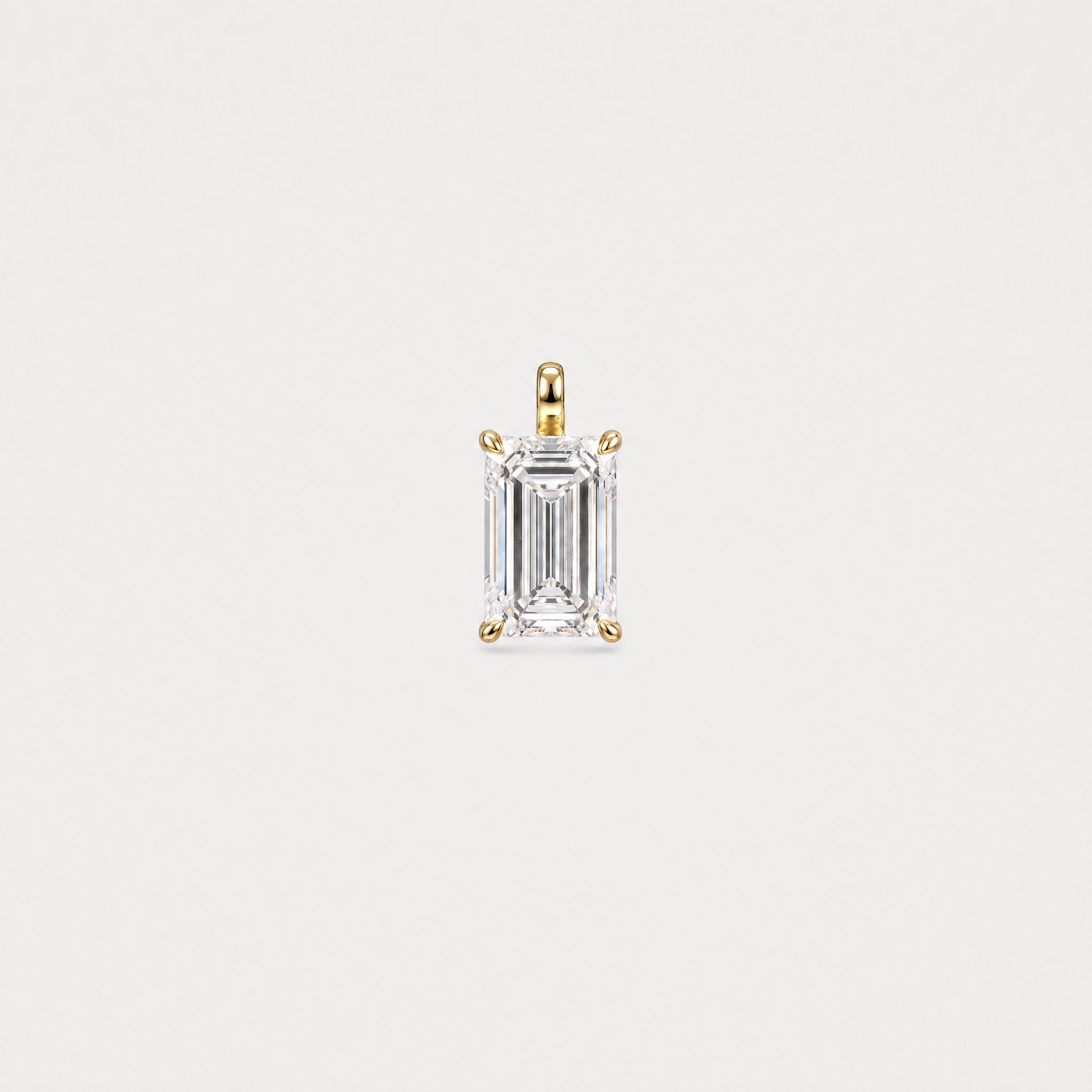 Front view of an emerald-cut solitaire pendant in yellow gold with a four-prong setting.