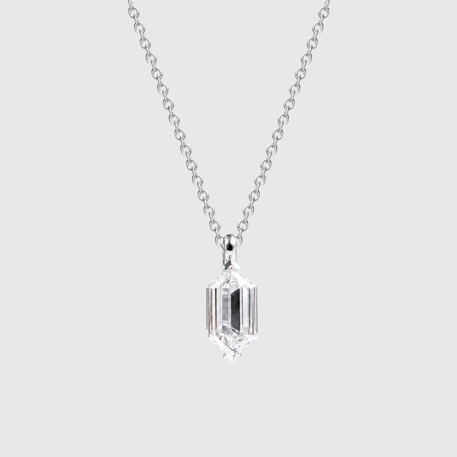 White metal elongated hexagon-cut diamond pendant shown on a chain from the front.