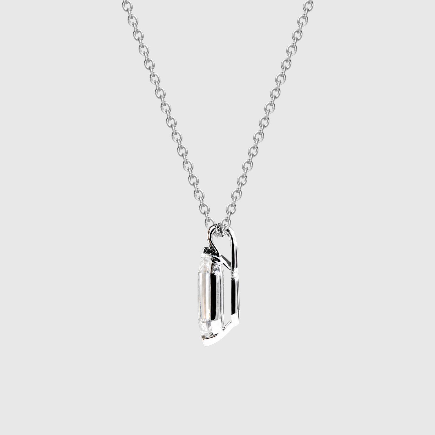 Side profile of an elongated hexagon-cut diamond pendant in white metal showing the open setting and bail.