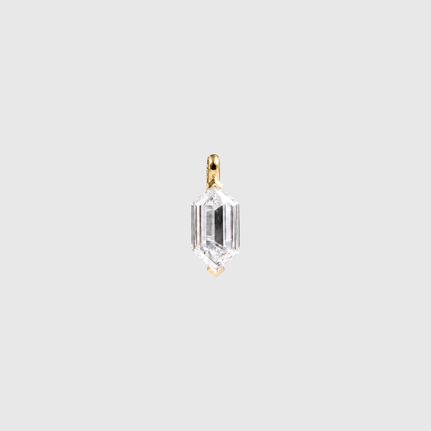 Front view of an elongated hexagon-cut diamond pendant in yellow metal on a light background.