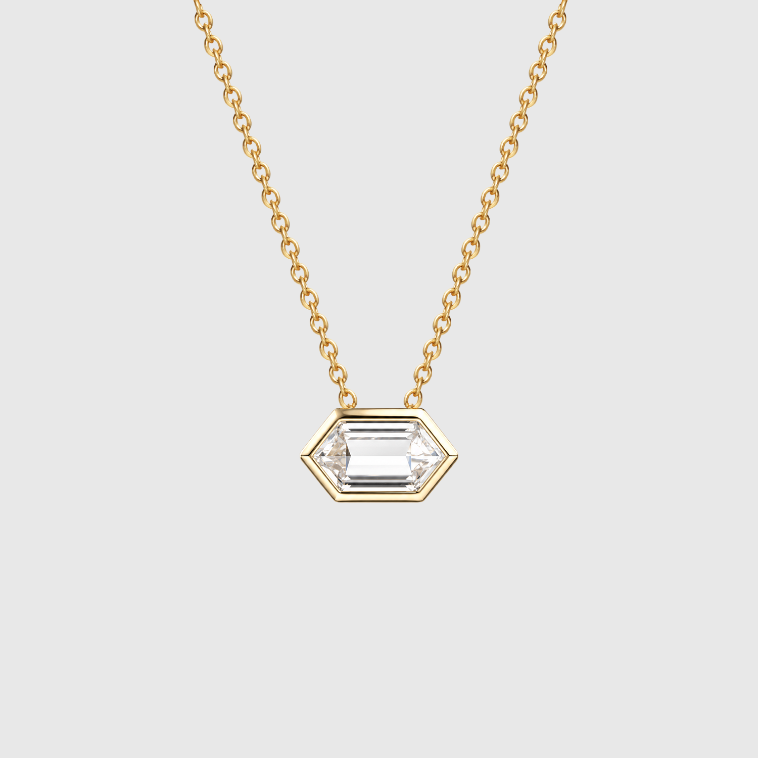 Front view of an elongated hexagon-cut diamond  pendant in yellow gold displayed on a fine chain.