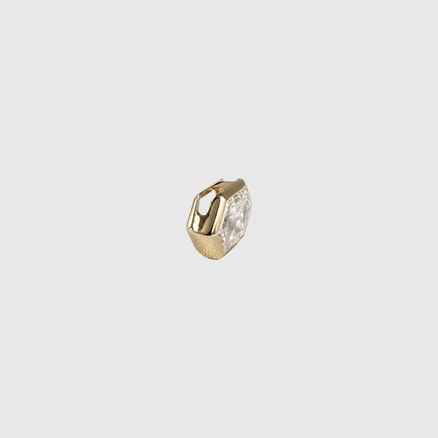 Side view of an elongated hexagon-cut diamond pendant in yellow gold showing the concealed bail and bezel profile.