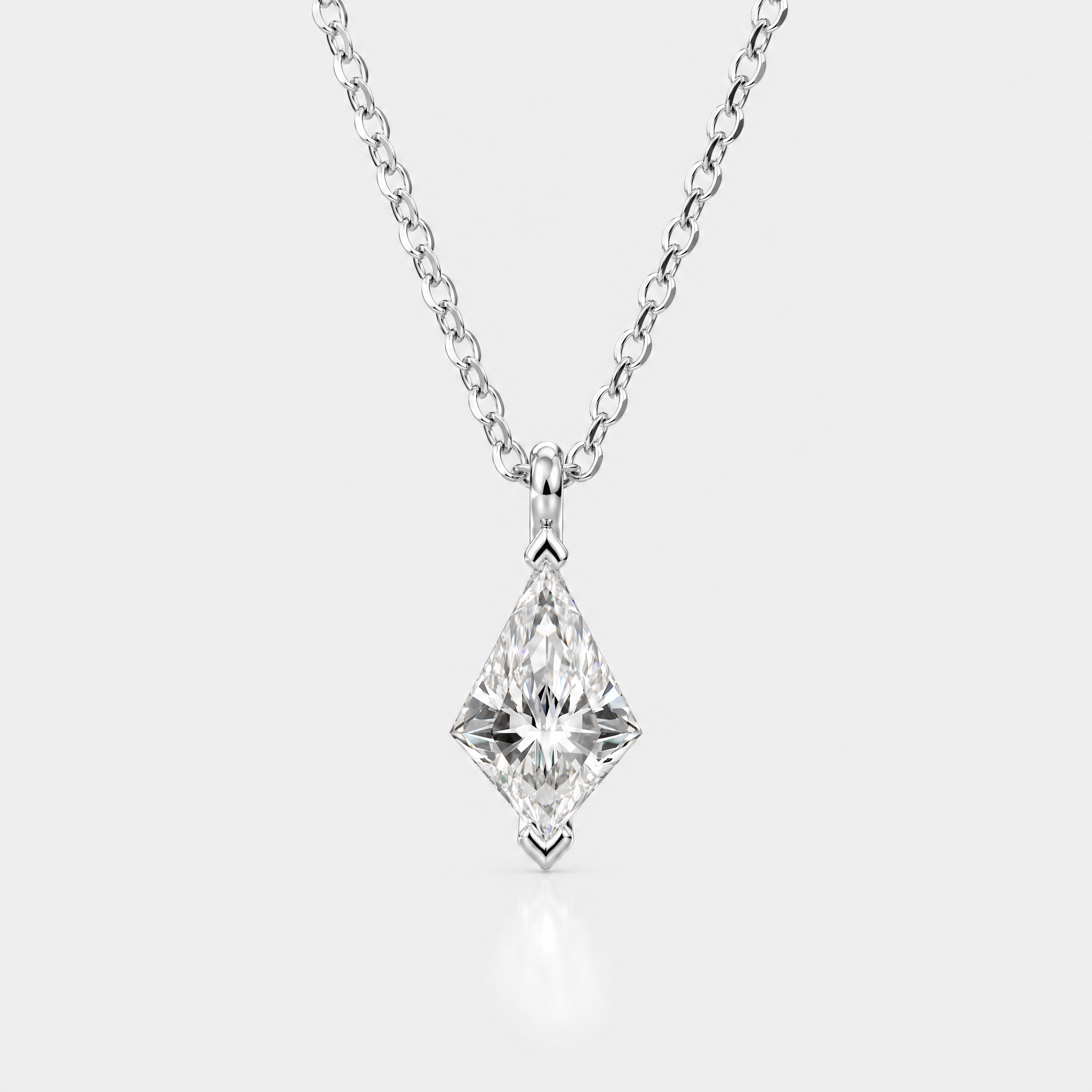 Front view of a kite-cut solitaire pendant in white metal displayed on a matching chain.