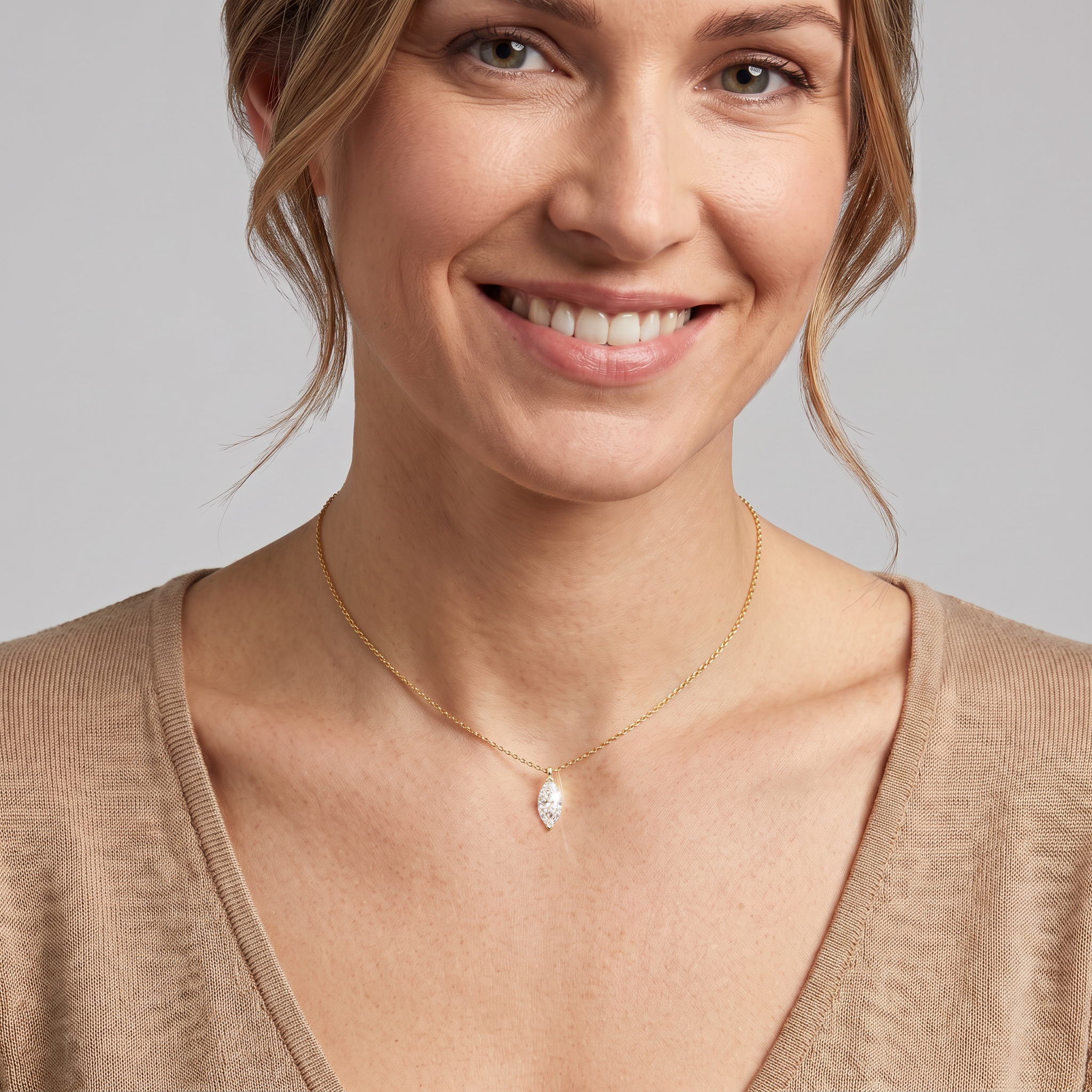 Yellow-gold marquise-cut pendant worn on a fine chain in a front neck view.