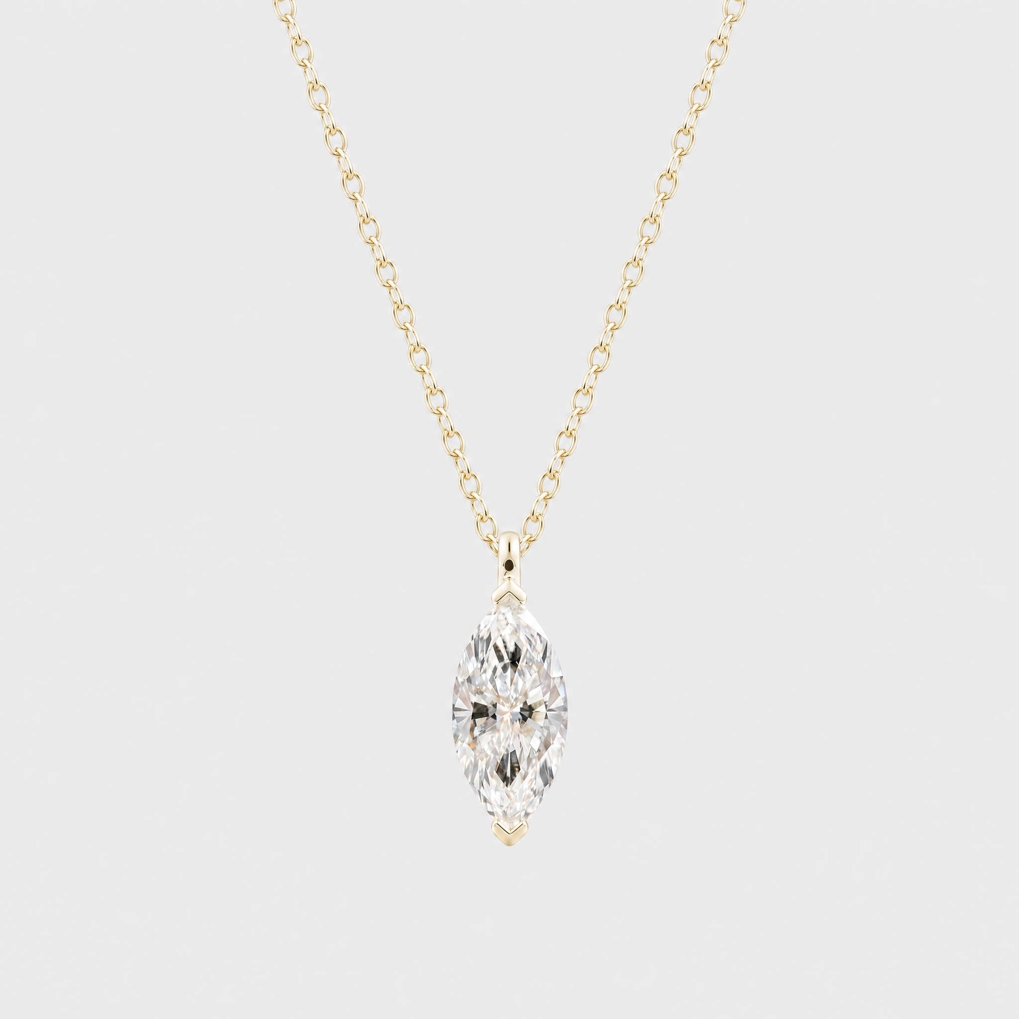 Front view of a marquise-cut solitaire pendant in yellow gold displayed on a matching chain.