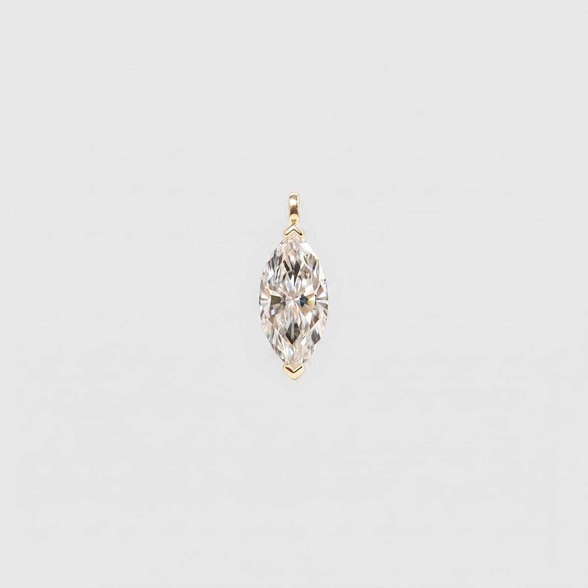 Front view of a marquise-cut solitaire pendant in yellow gold with protective tip prongs.