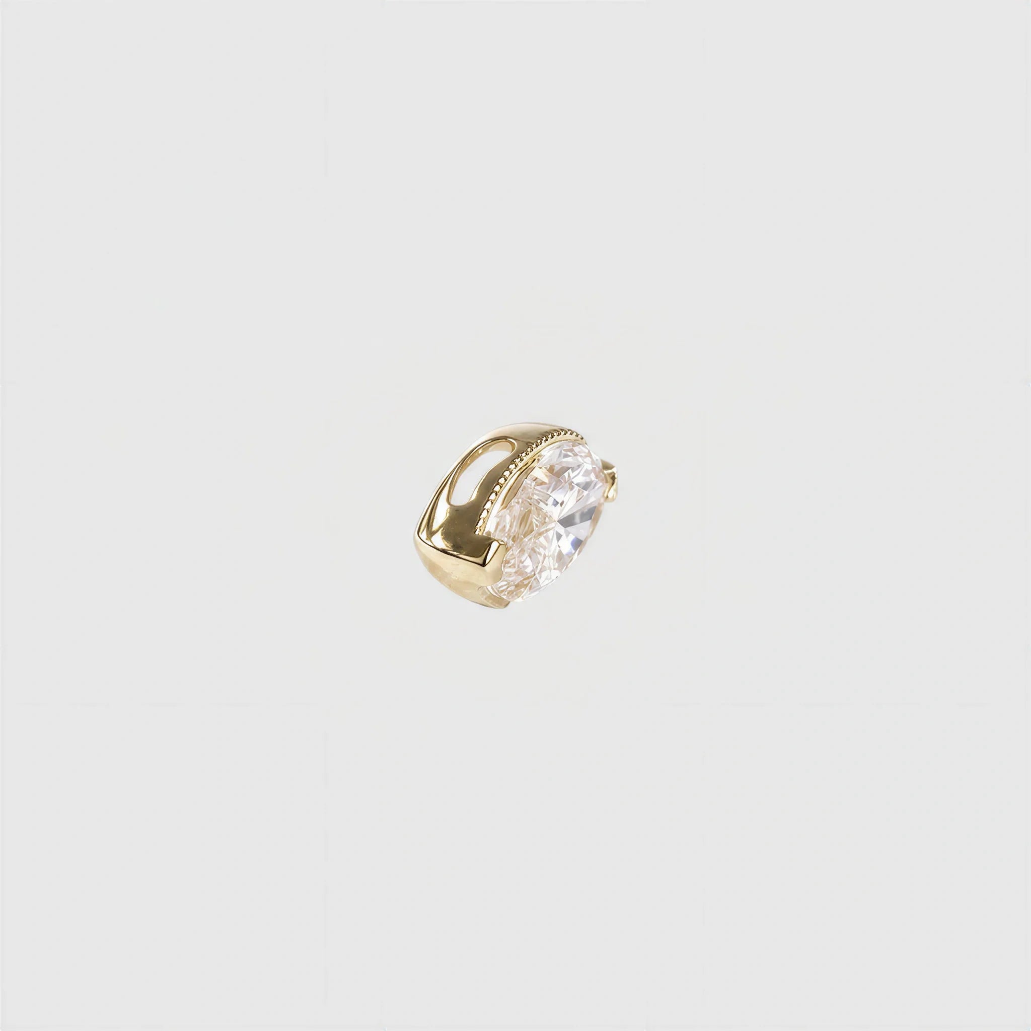 Side view of a marquise-cut diamond pendant in yellow gold showing the bezel profile and concealed bail.