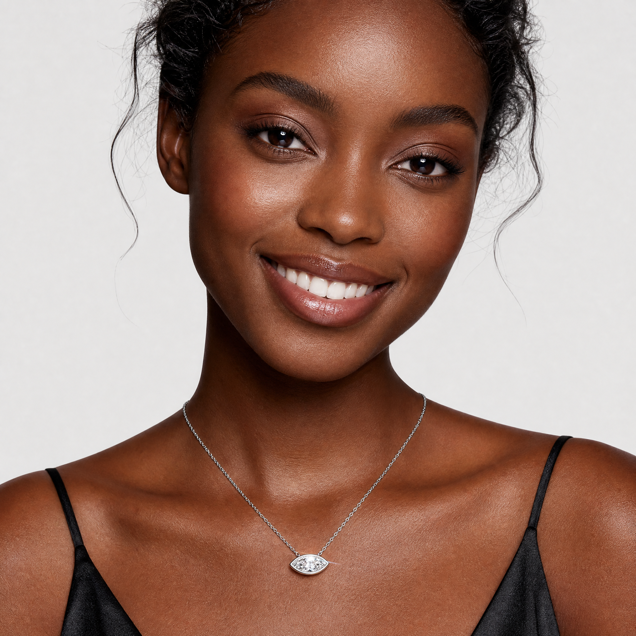 Model wearing a white gold east-west marquise diamond pendant necklace.