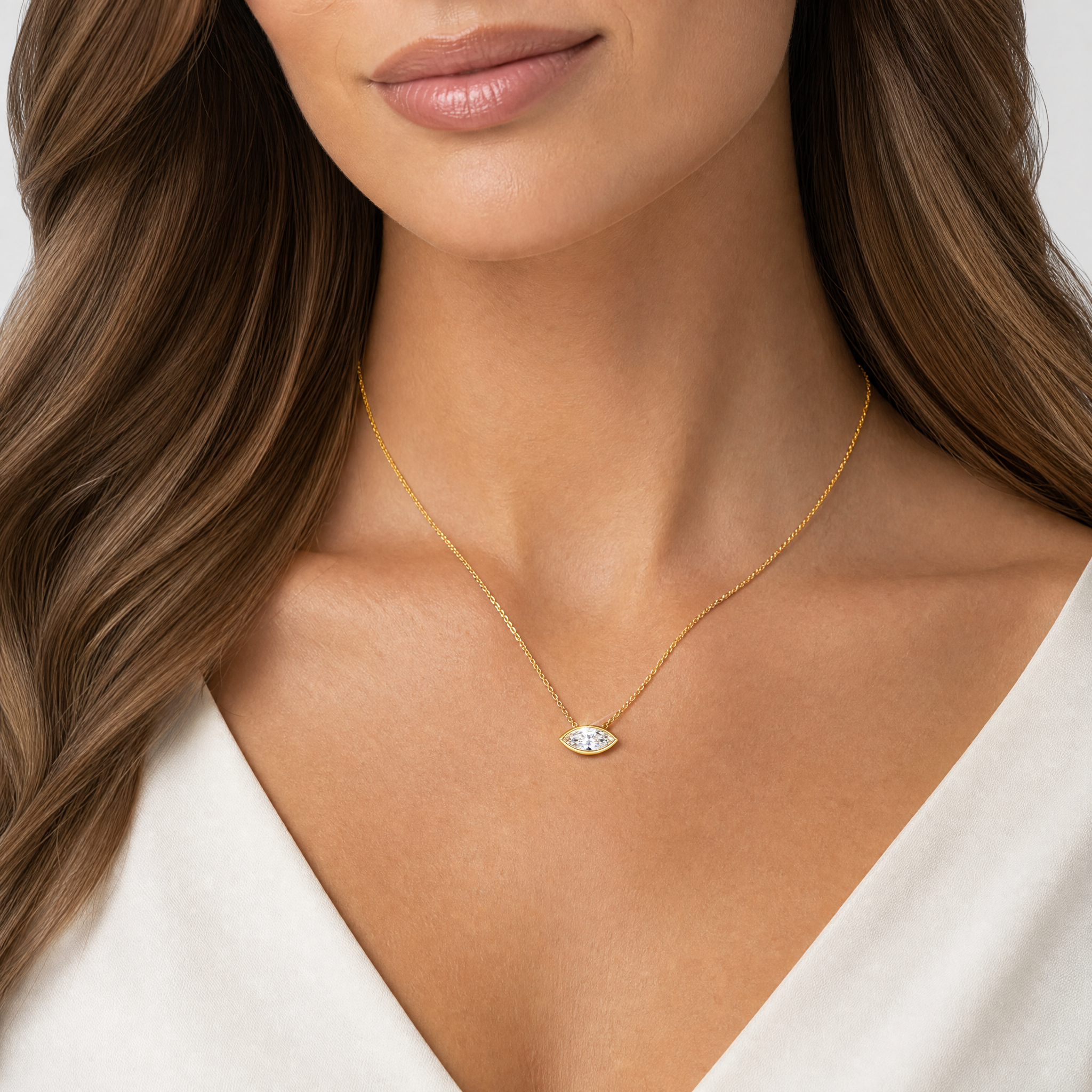 Model wearing a yellow gold east-west marquise diamond pendant necklace.