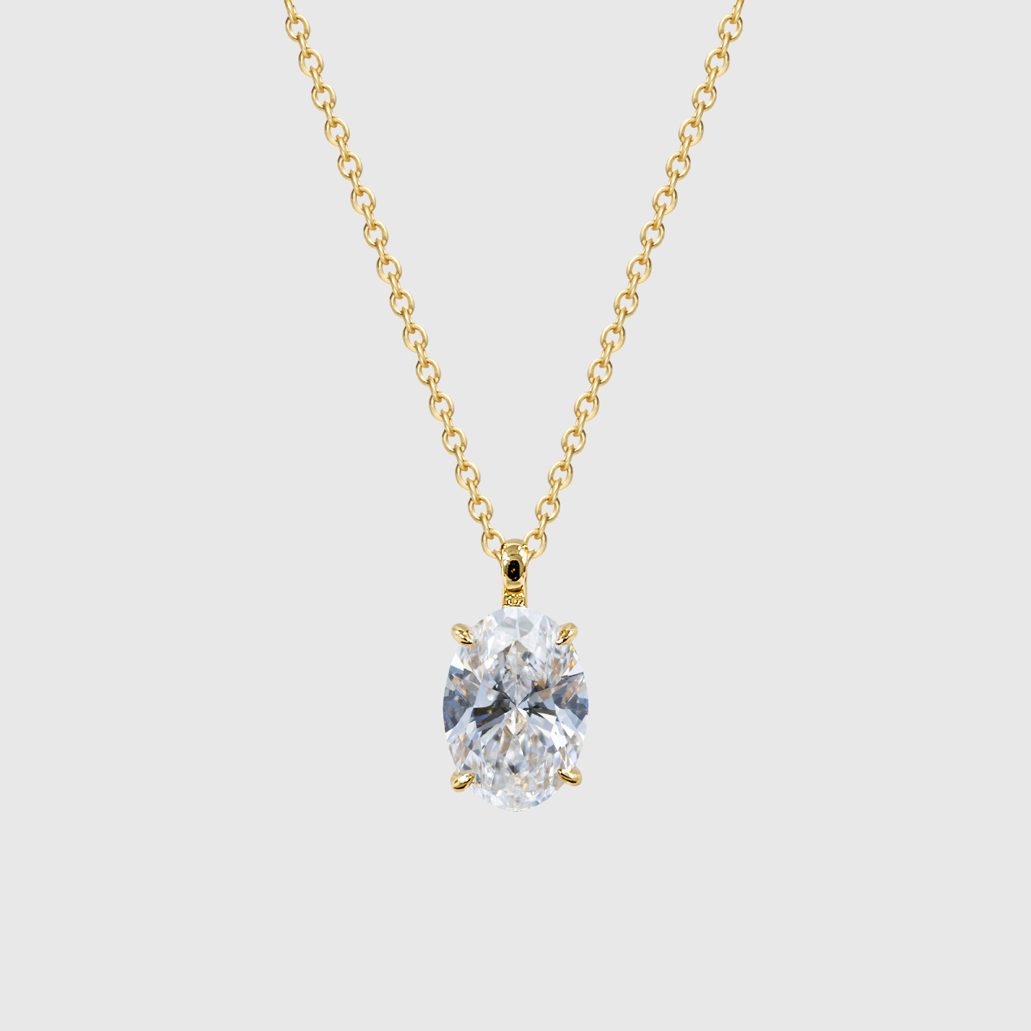 Yellow gold oval diamond pendant displayed on a chain.