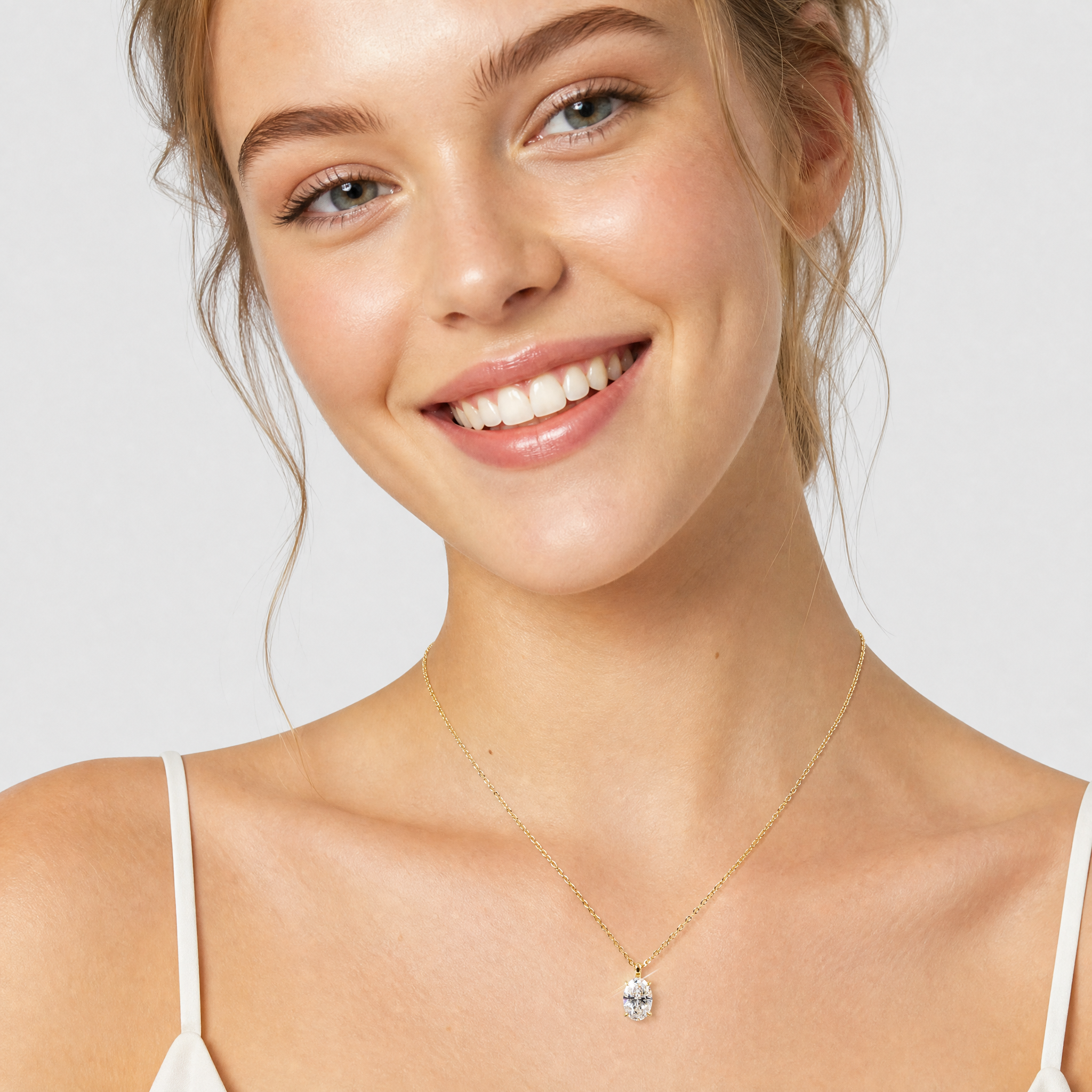 Model wearing a yellow gold oval diamond pendant necklace.