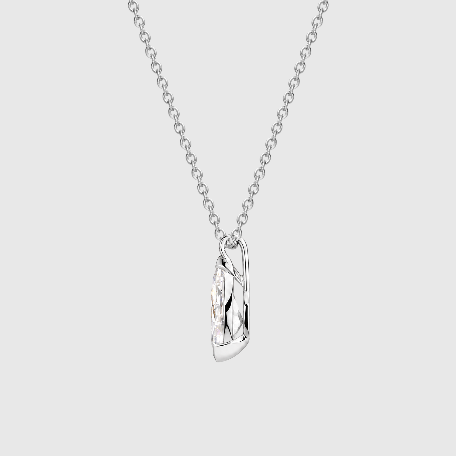 Side view of a pear-cut diamond pendant in white gold showing the half-bezel profile and bail.