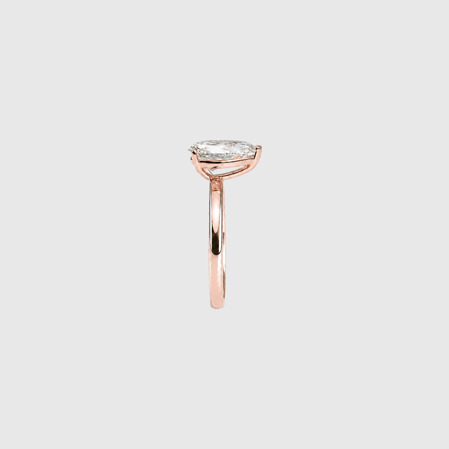 Pear-shaped lab-grown diamond solitaire engagement ring in rose gold, side view.