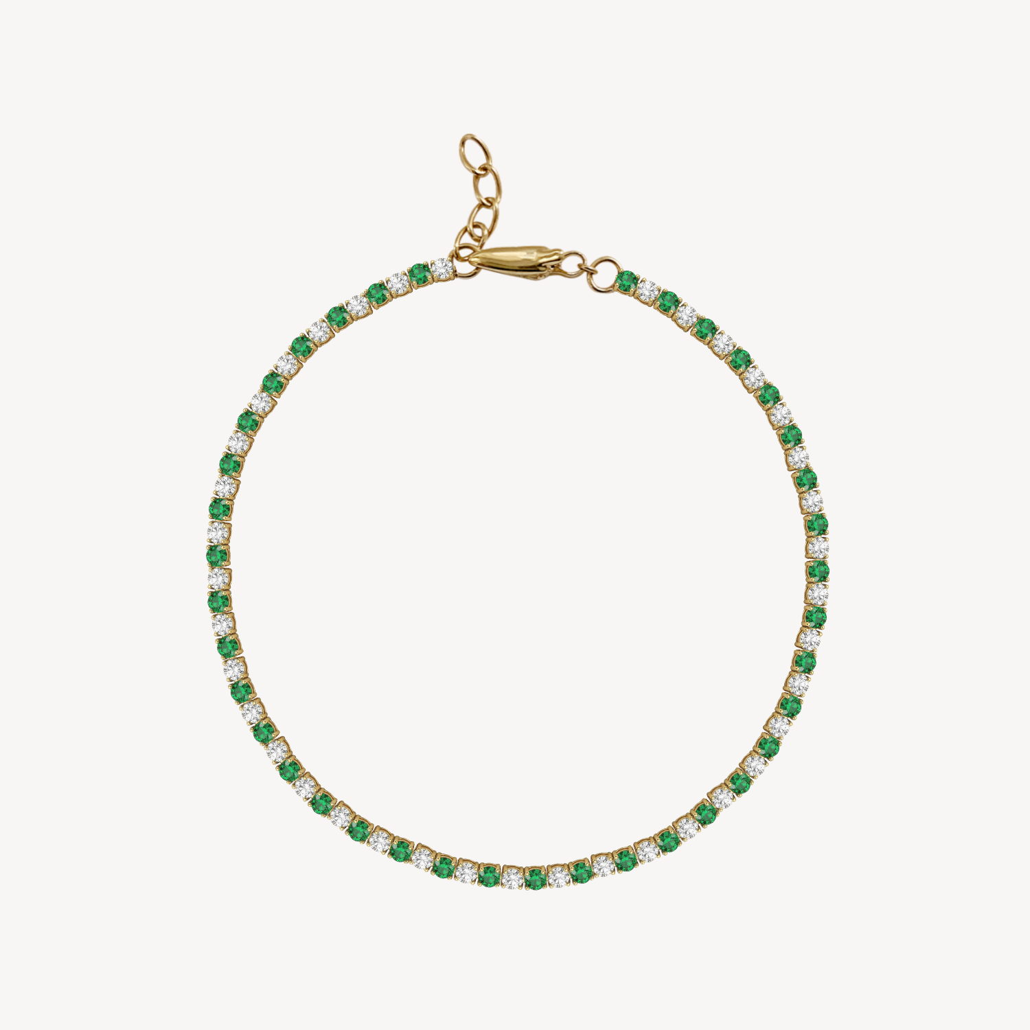 Gold bracelet with diamond and emerald on a white background