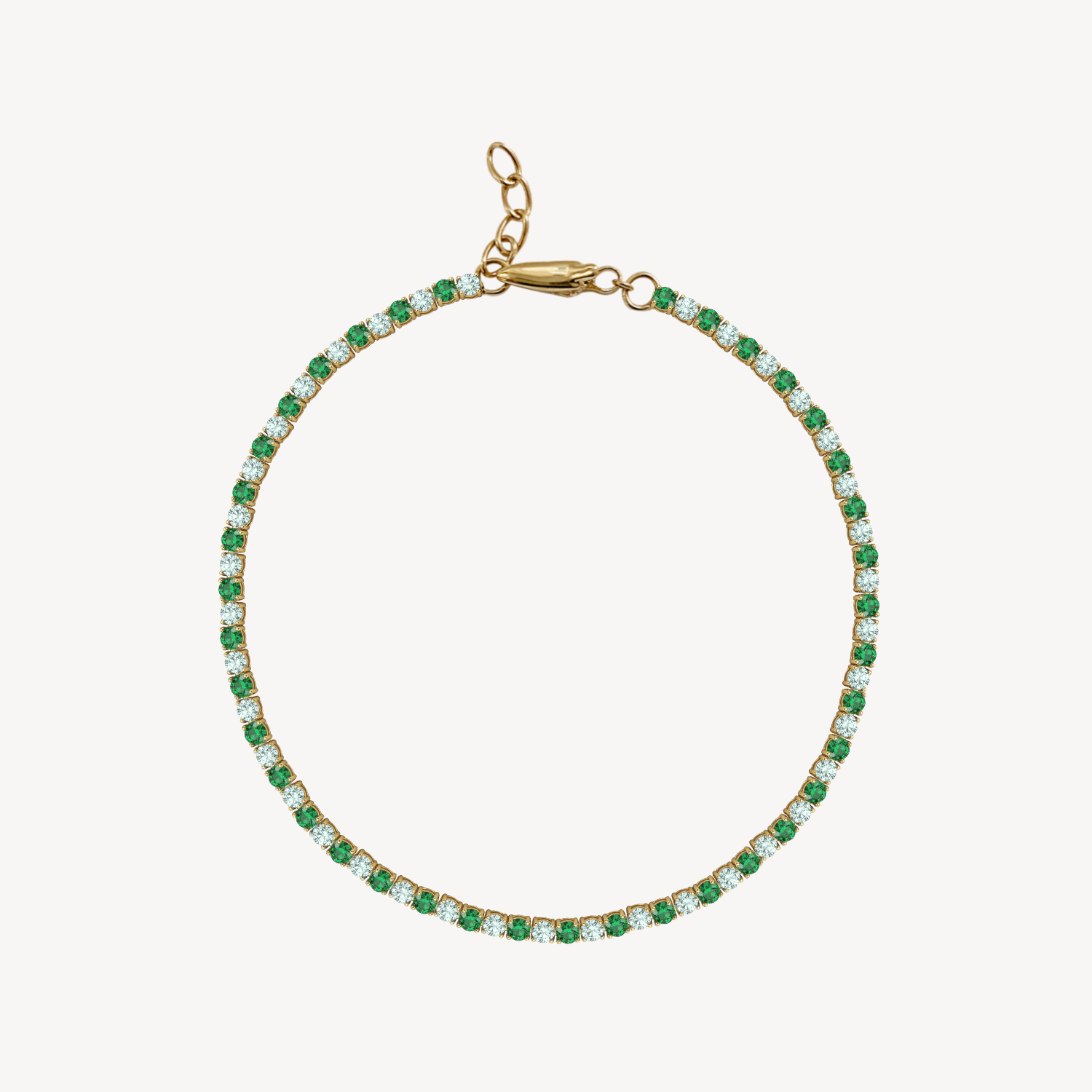 Gold bracelet with emerald and green sapphire  on a white background