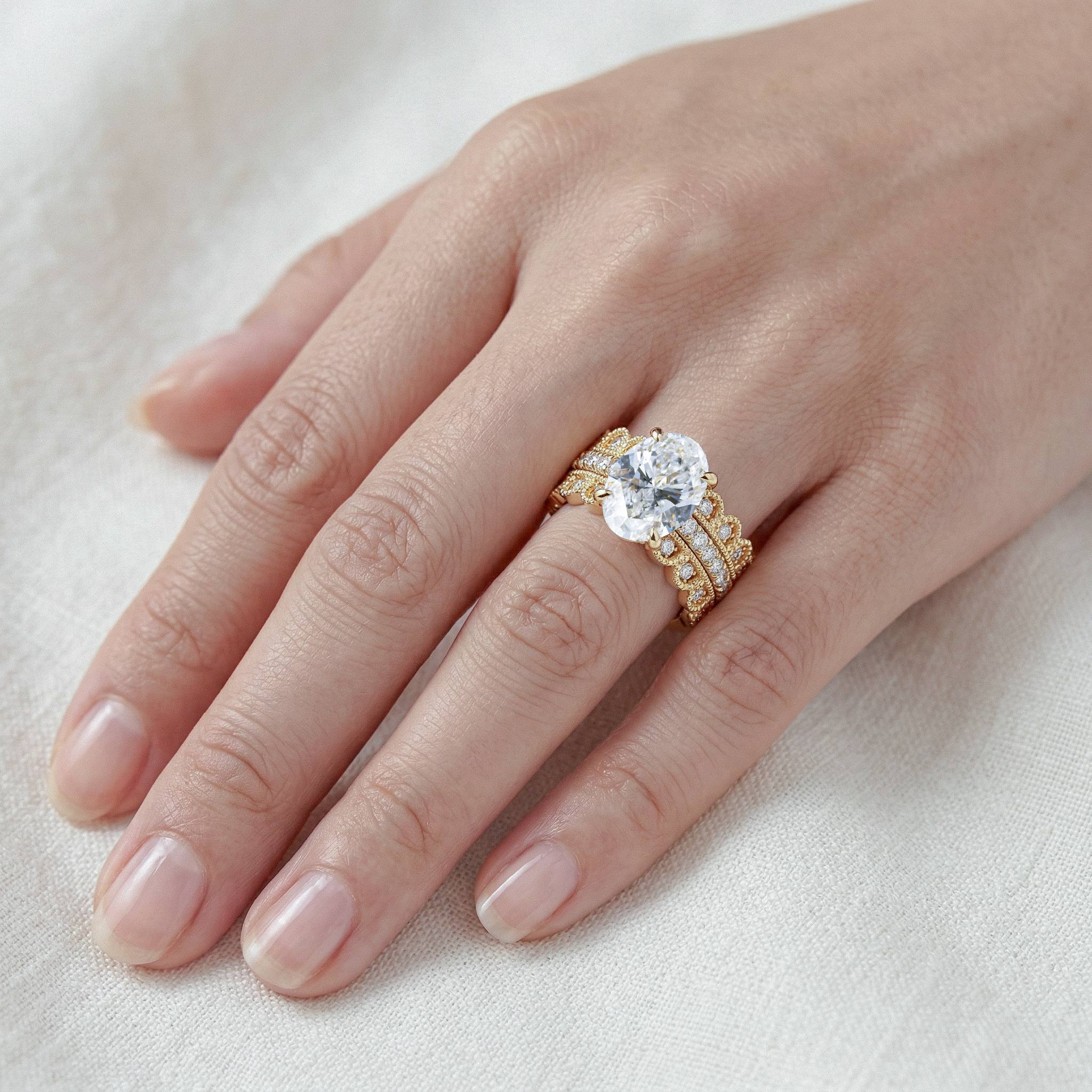 Gold set 3pcs rings with oval cut diamond on a hand 