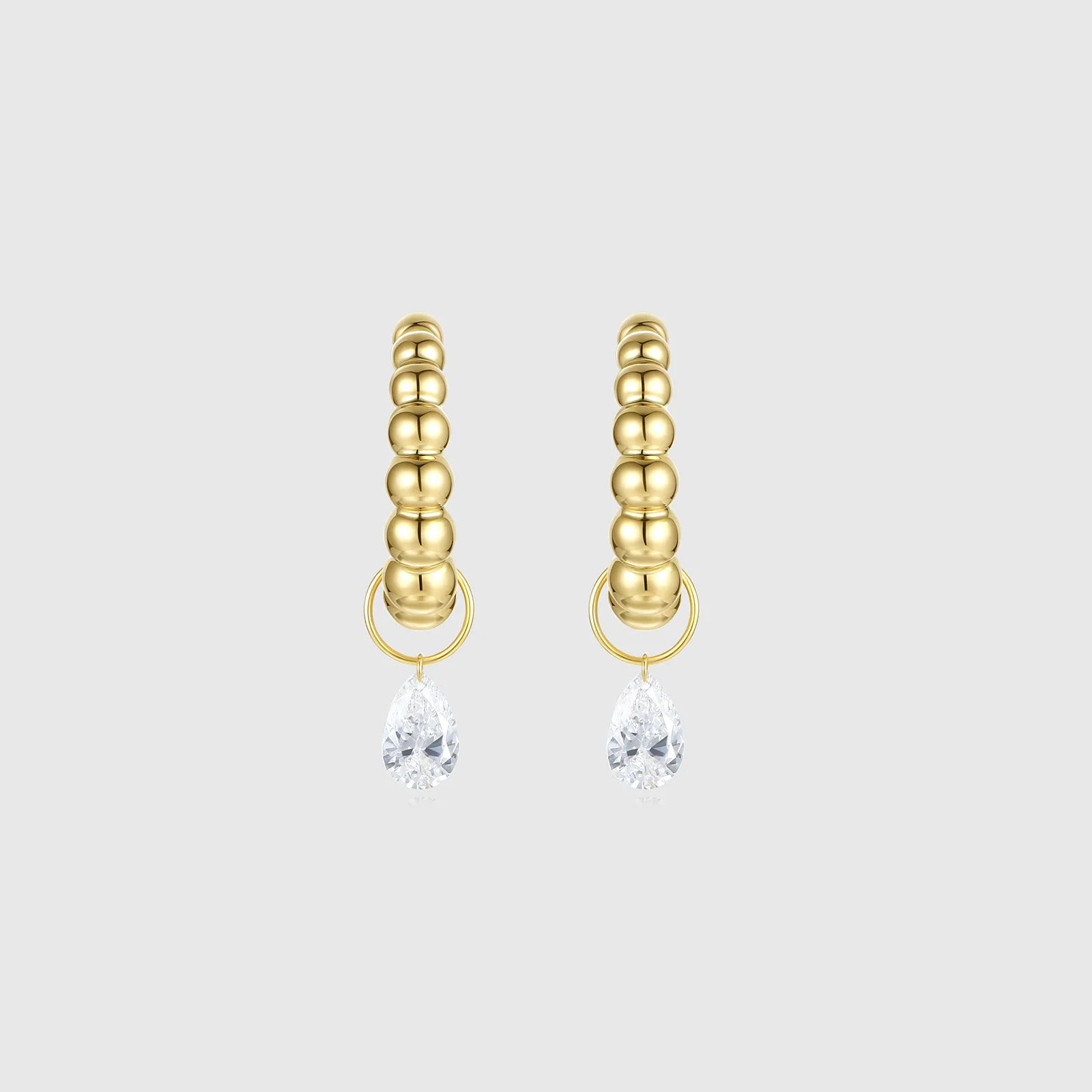 Gold beaded hoop earrings with pear-shaped diamond drops
