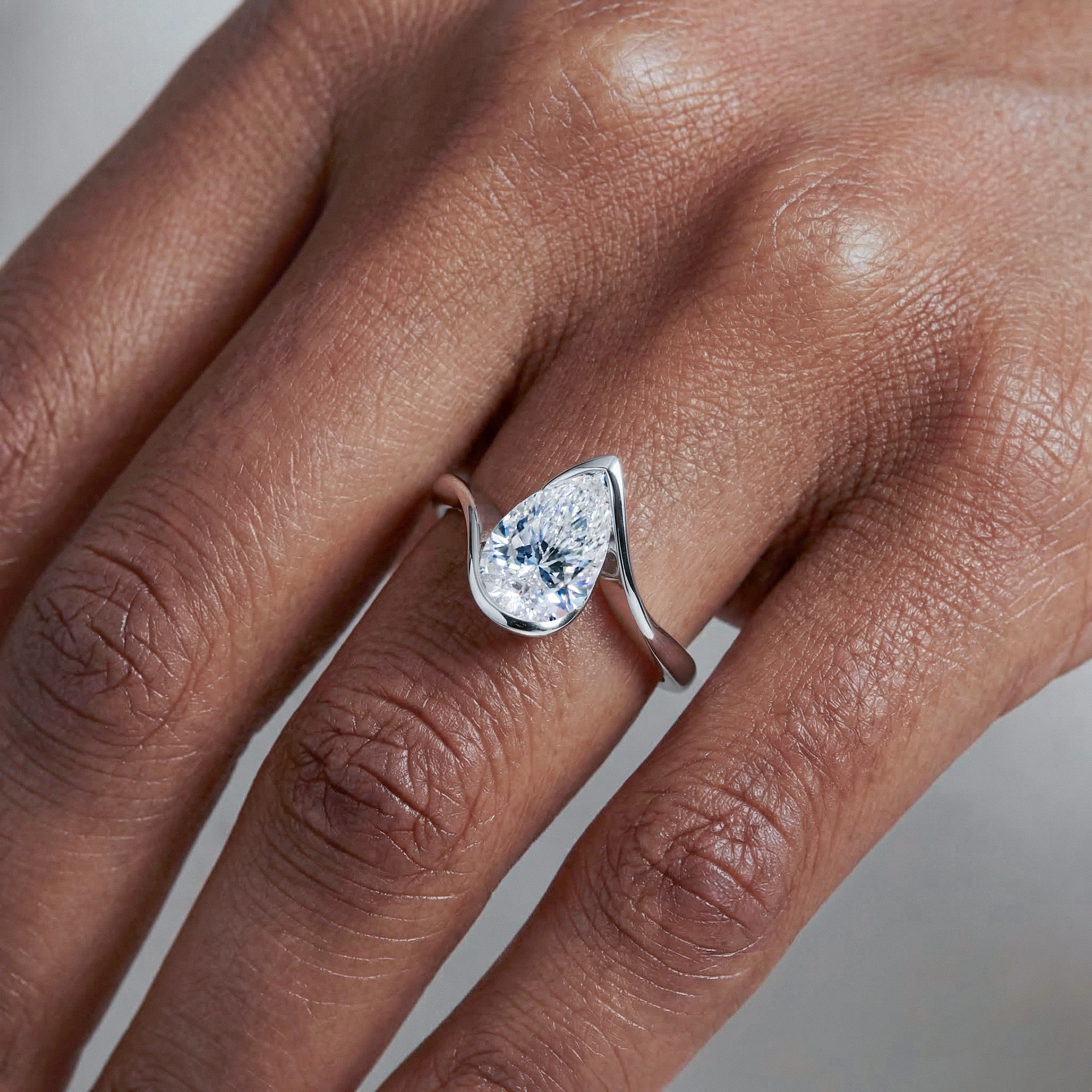 Celeste Pear Twist Lab Diamond Engagement Ring| Half Bezel