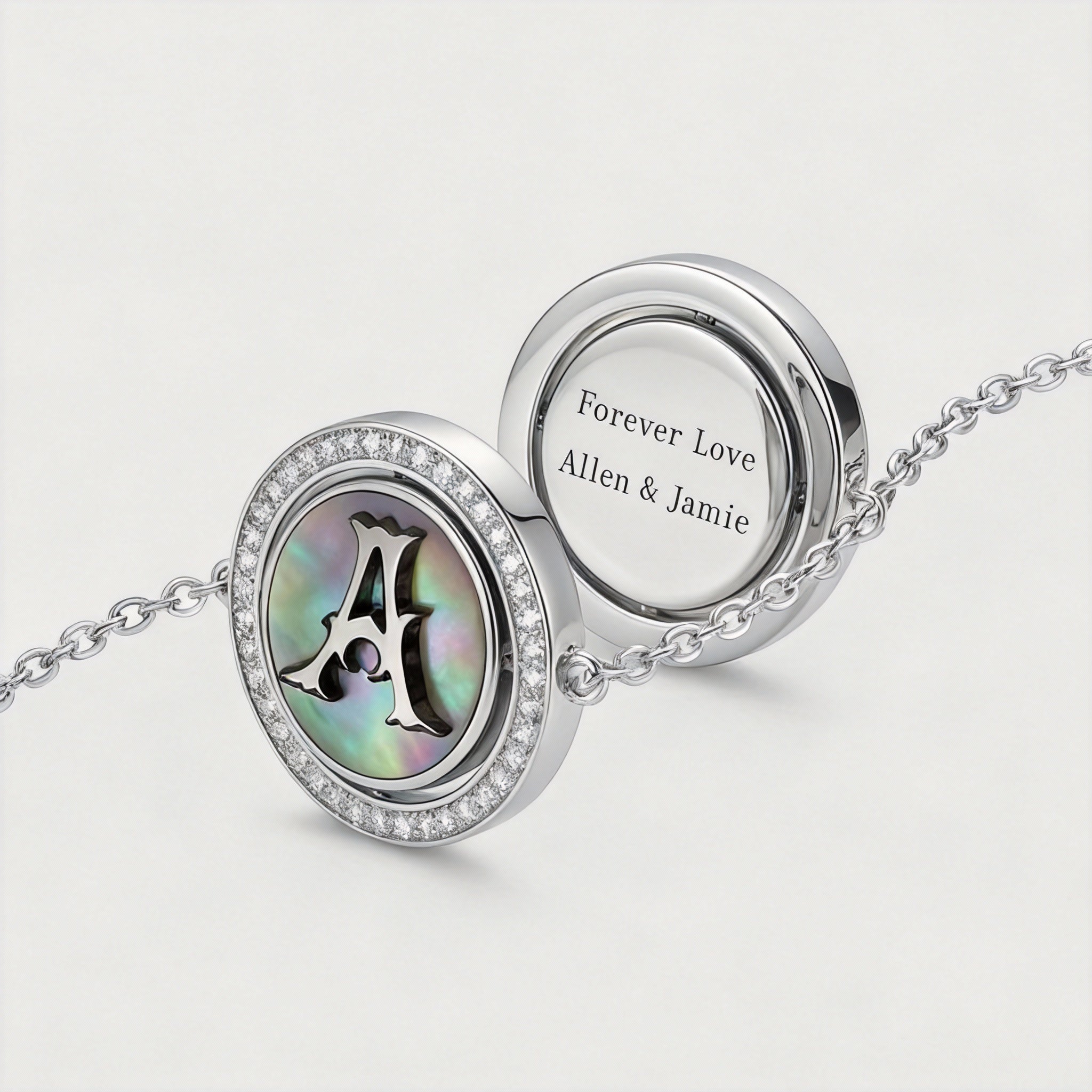 Reversible personalized initial diamond bracelet with a black mother-of-pearl background, shown on a 925 sterling silver chain.