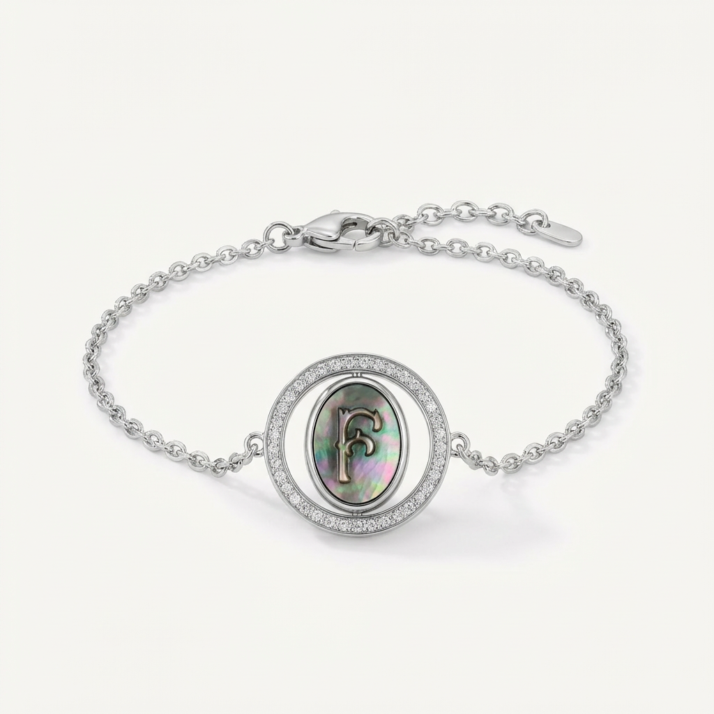 Reversible personalized initial diamond bracelet with a black mother-of-pearl background, shown on a 925 sterling silver chain.