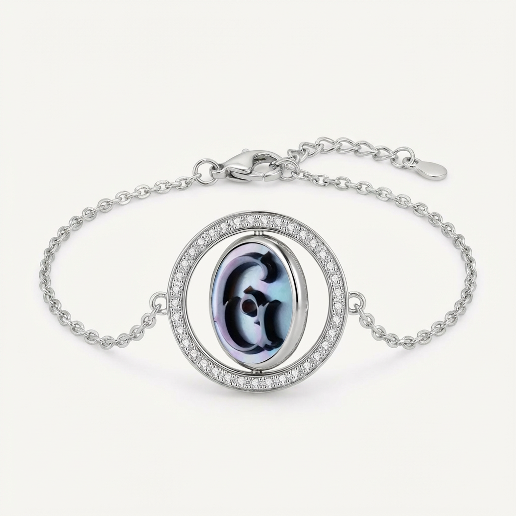 Reversible personalized initial diamond bracelet with a black mother-of-pearl background, shown on a 925 sterling silver chain.