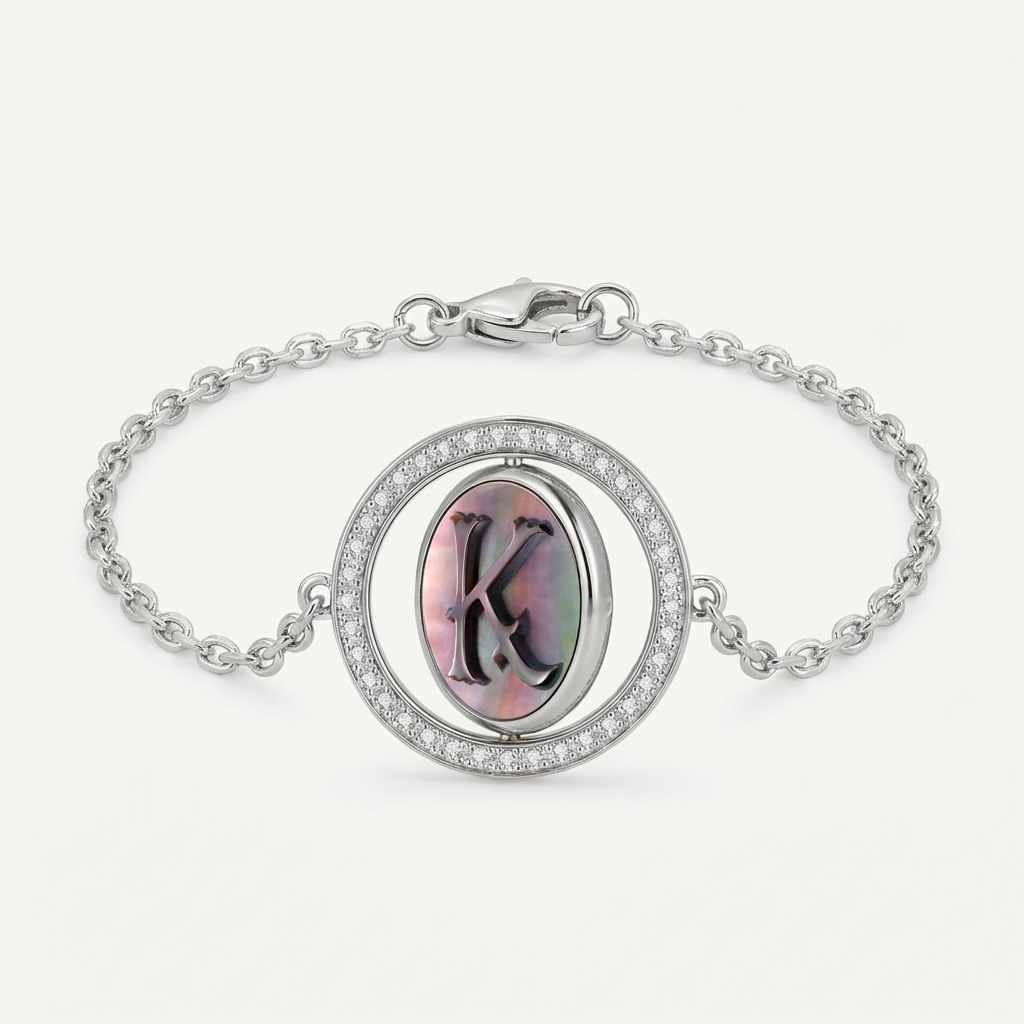 Reversible personalized initial diamond bracelet with a black mother-of-pearl background, shown on a 925 sterling silver chain.