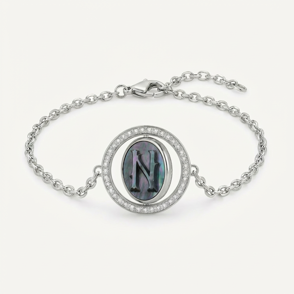 Reversible personalized initial diamond necklace with a black mother-of-pearl background, shown on a 925 sterling silver chain.