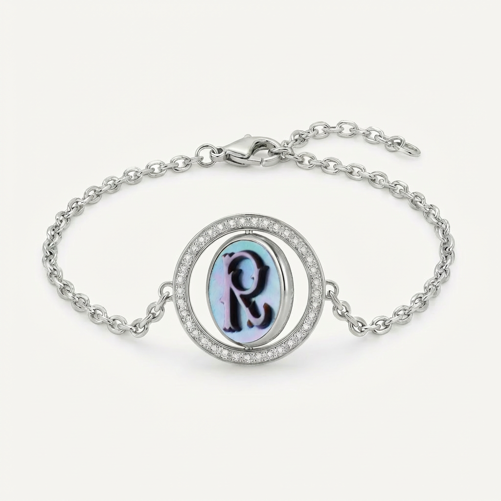 Reversible personalized initial diamond bracelet with a black mother-of-pearl background, shown on a 925 sterling silver chain.