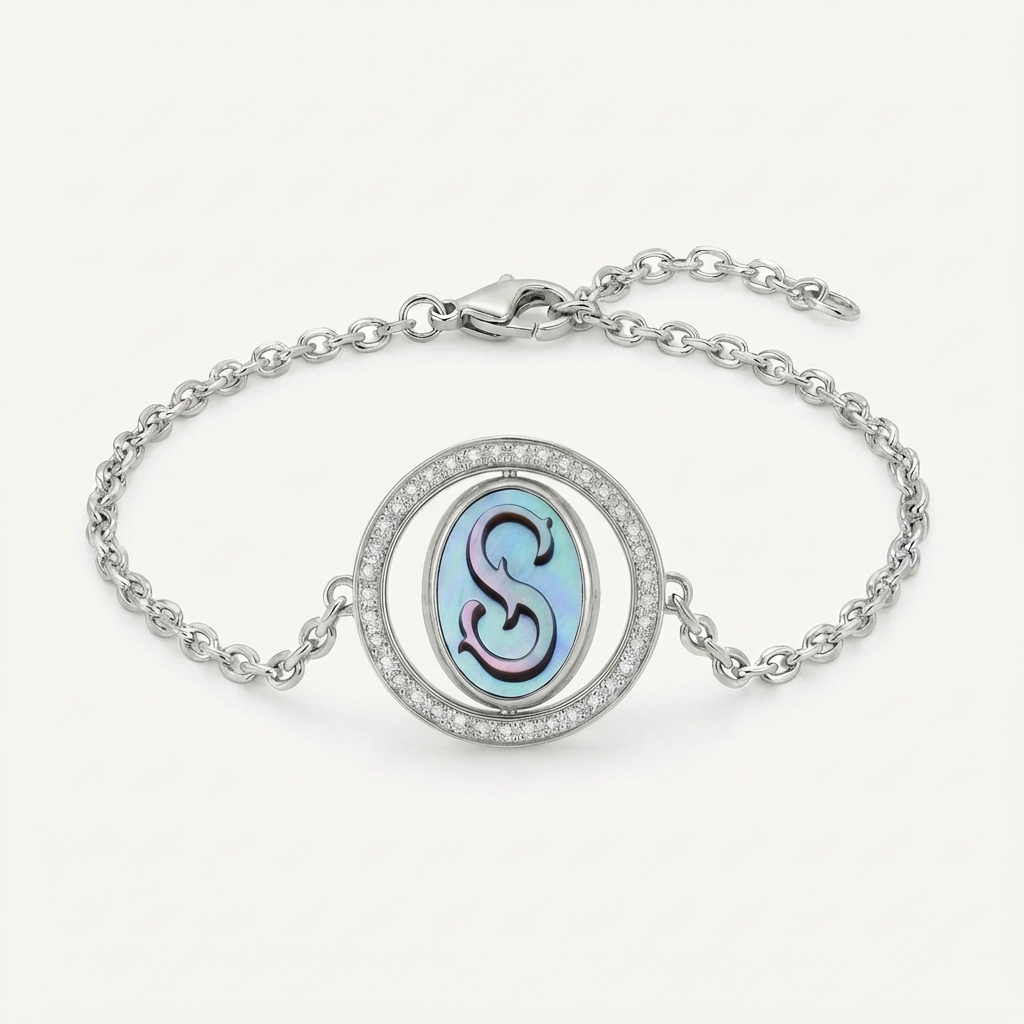 Reversible personalized initial diamond bracelet with a black mother-of-pearl background, shown on a 925 sterling silver chain.
