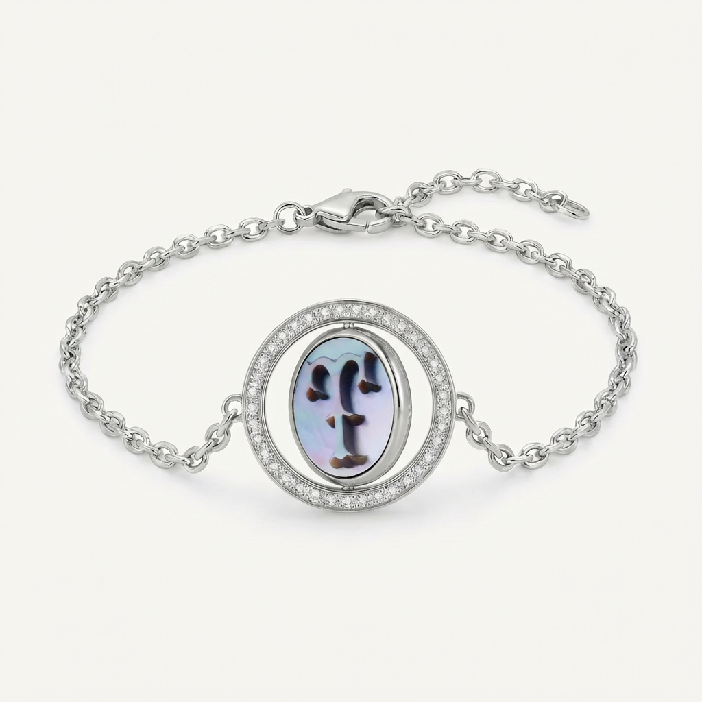 Reversible personalized initial diamond bracelet with a black mother-of-pearl background, shown on a 925 sterling silver chain.