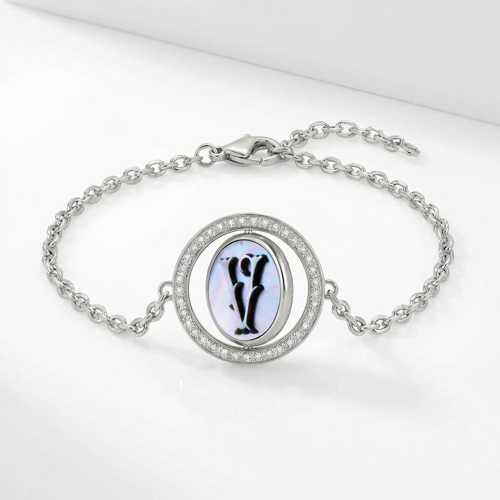 Reversible personalized initial diamond bracelet with a black mother-of-pearl background, shown on a 925 sterling silver chain.