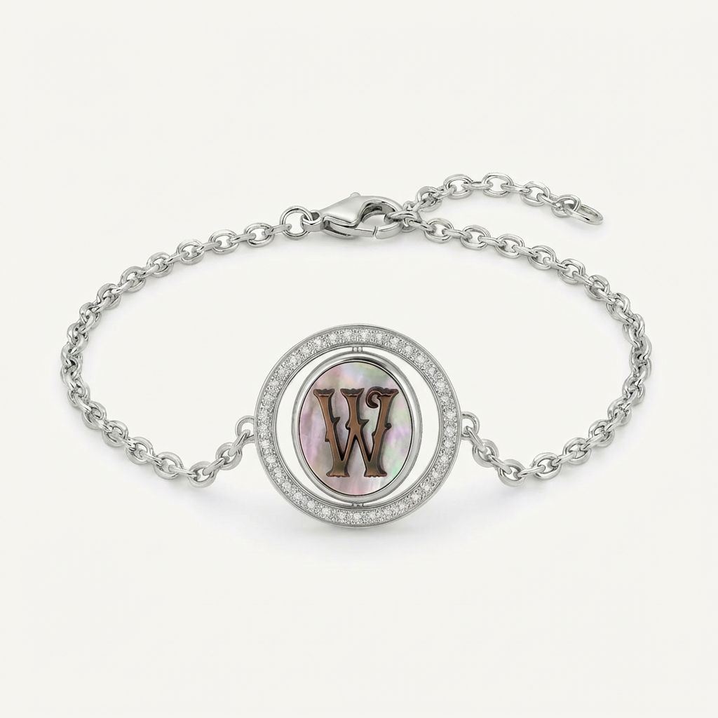 Reversible personalized initial diamond bracelet with a black mother-of-pearl background, shown on a 925 sterling silver chain.