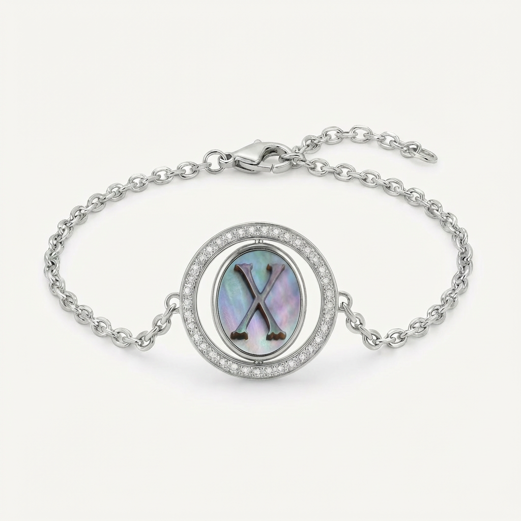 Reversible personalized initial diamond bracelet with a black mother-of-pearl background, shown on a 925 sterling silver chain.
