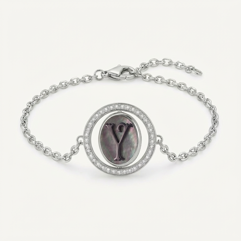 Reversible personalized initial diamond bracelet with a black mother-of-pearl background, shown on a 925 sterling silver chain.