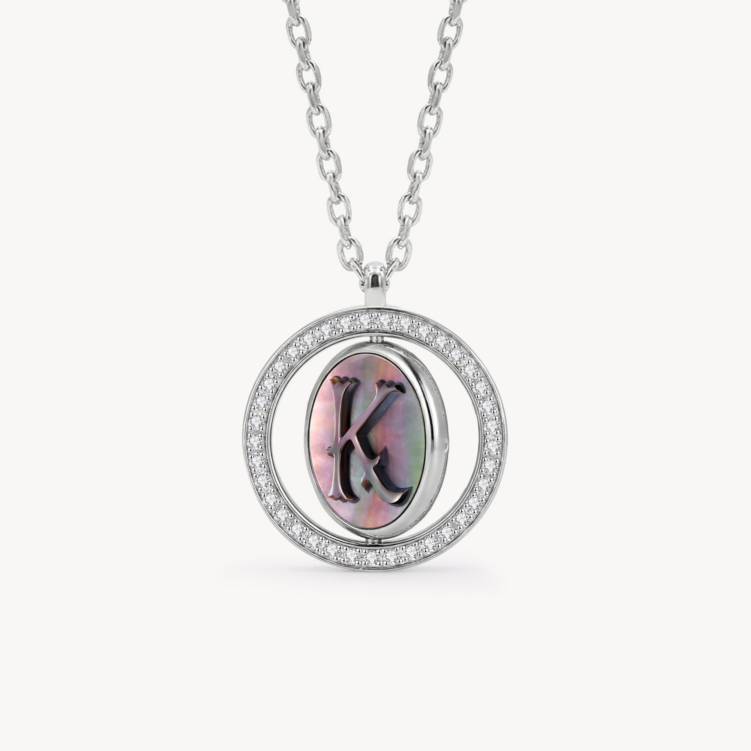 Reversible personalized initial diamond necklace with a black mother-of-pearl background, shown on a 925 sterling silver chain.