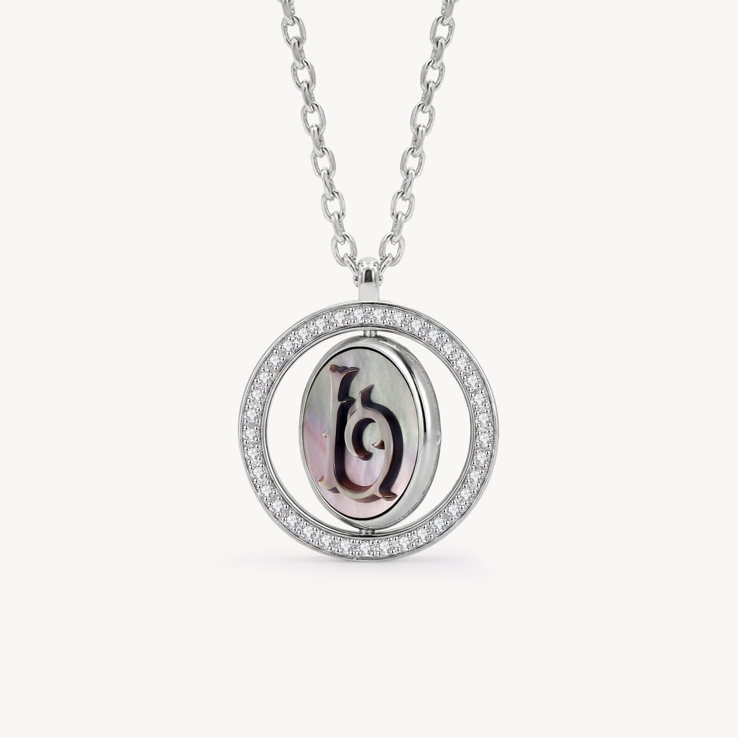 Reversible personalized initial diamond necklace with a black mother-of-pearl background, shown on a 925 sterling silver chain.