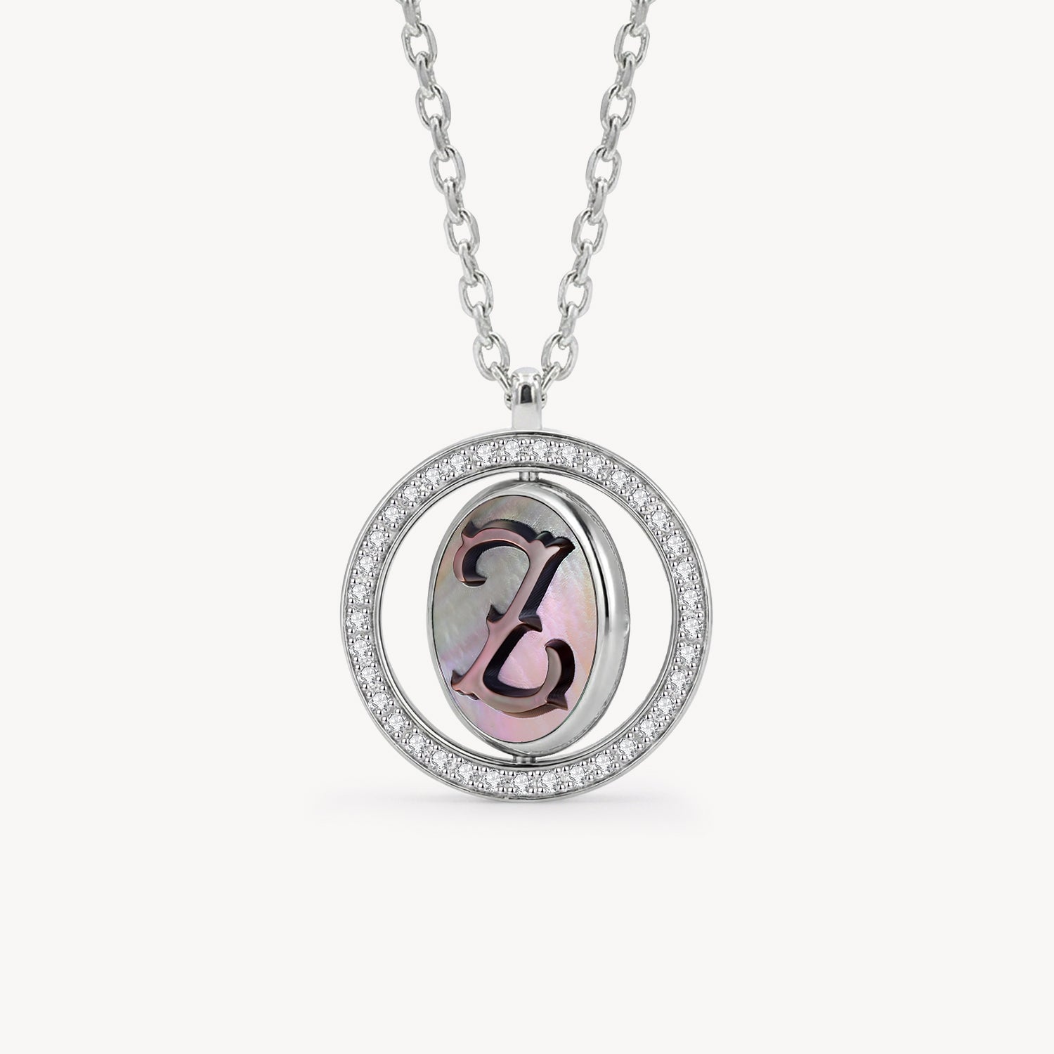 Reversible personalized initial diamond necklace with a black mother-of-pearl background, shown on a 925 sterling silver chain.