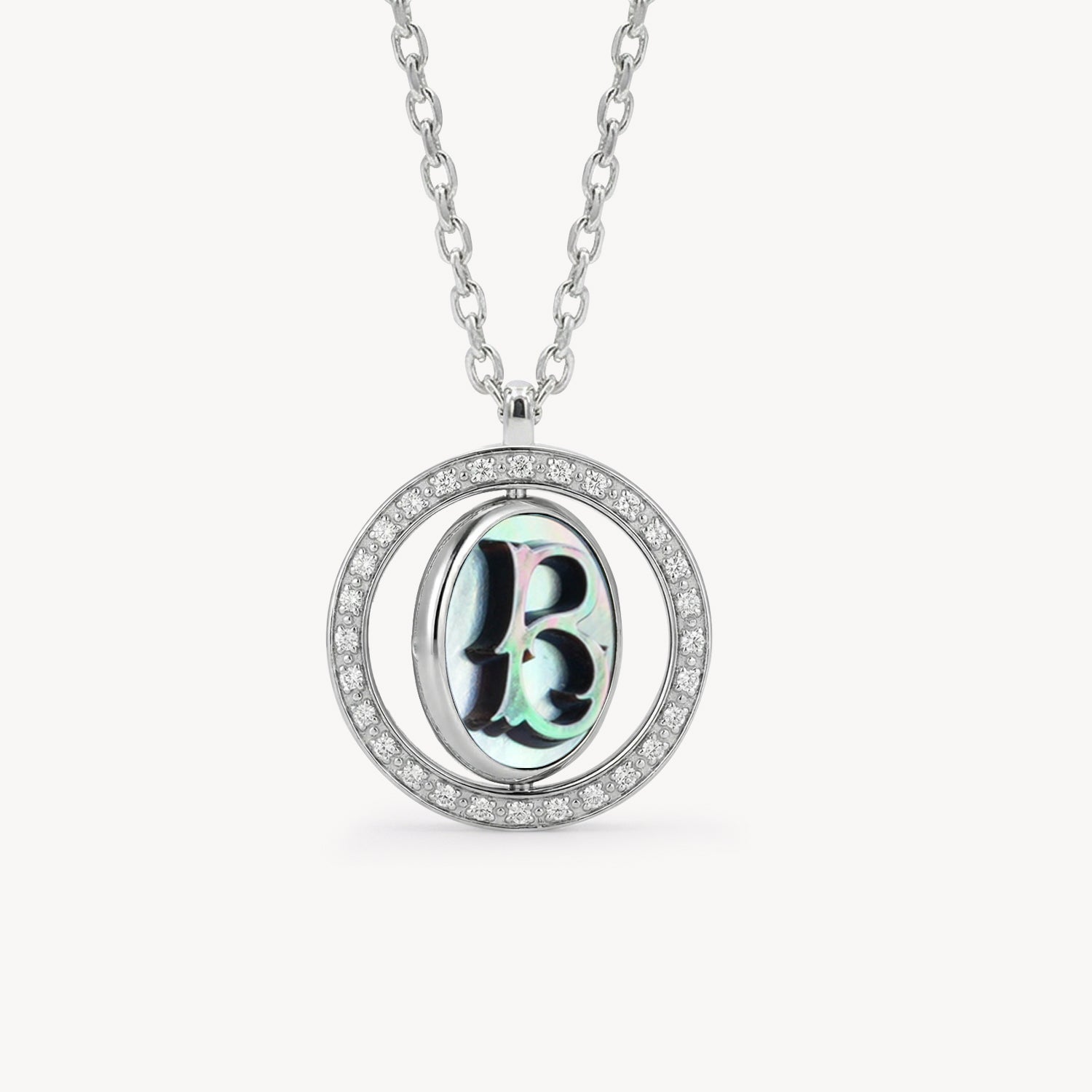 Reversible personalized initial diamond necklace with a black mother-of-pearl background, shown on a 925 sterling silver chain.