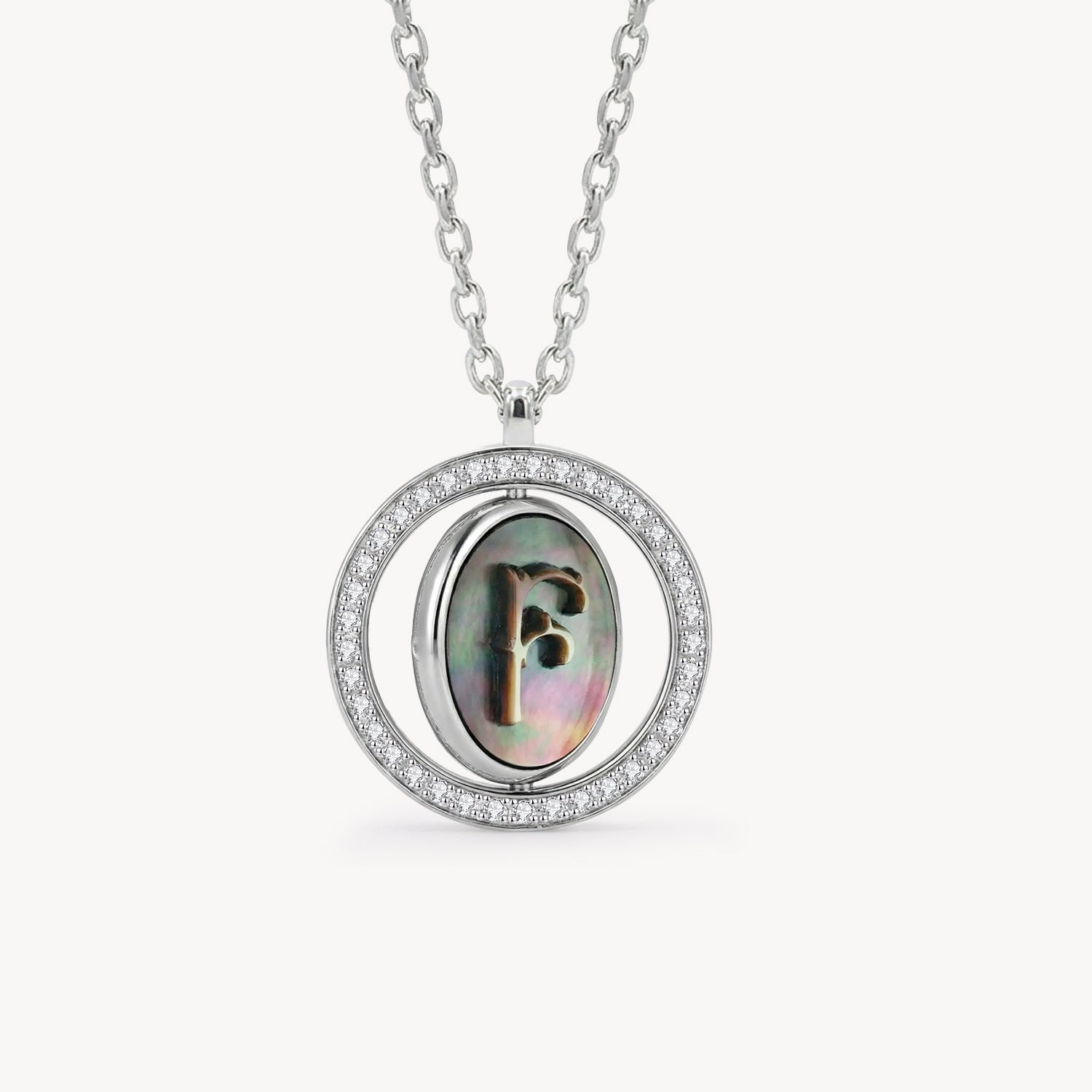 Reversible personalized initial diamond necklace with a black mother-of-pearl background, shown on a 925 sterling silver chain.