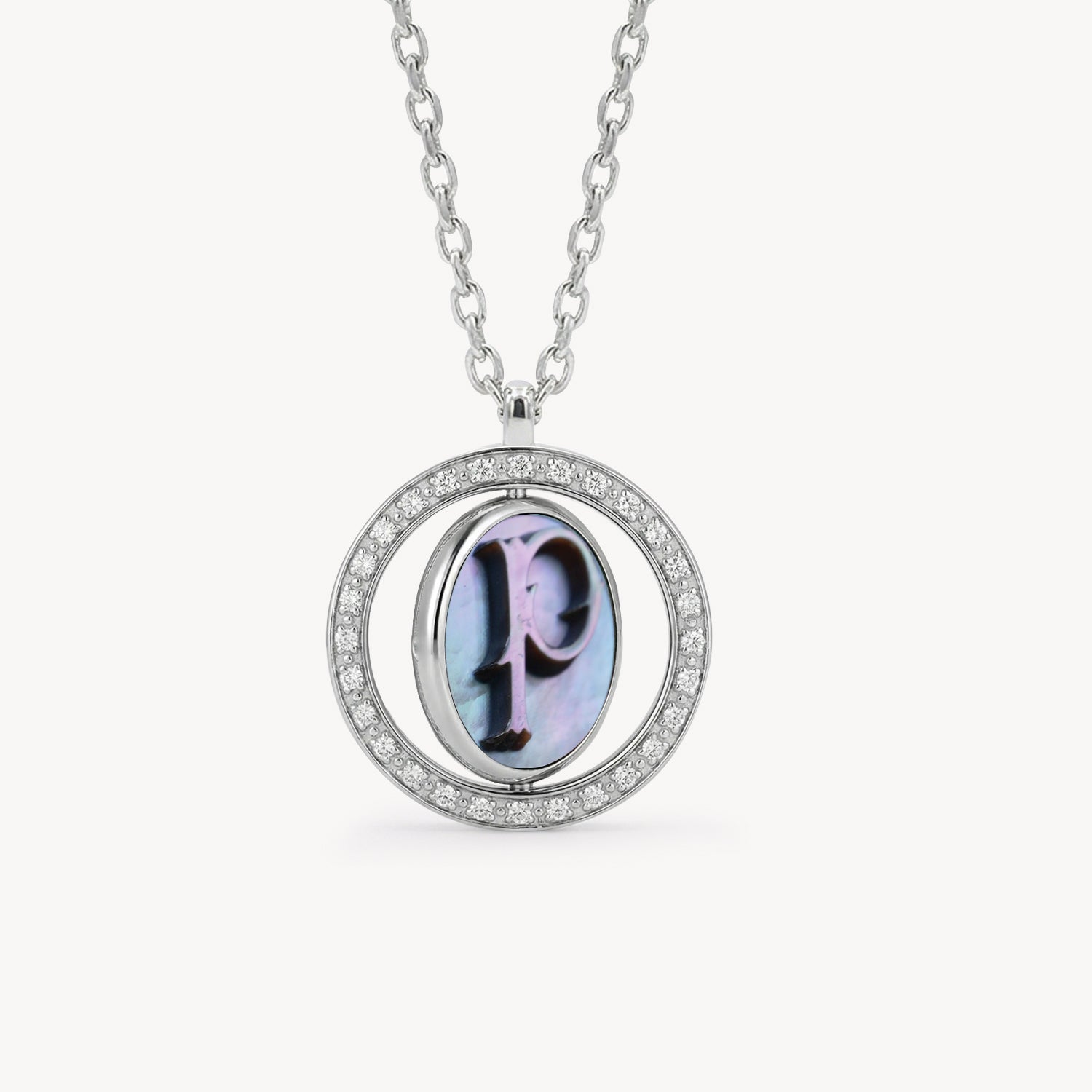 Reversible personalized initial diamond necklace with a black mother-of-pearl background, shown on a 925 sterling silver chain.