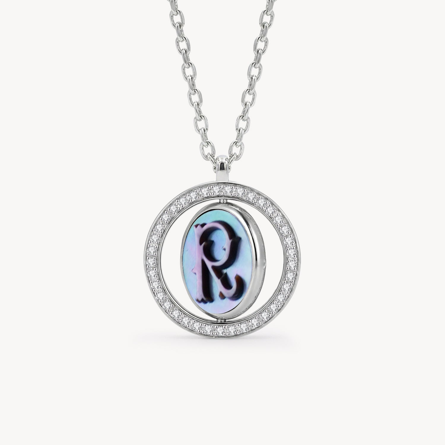 Reversible personalized initial diamond necklace with a black mother-of-pearl background, shown on a 925 sterling silver chain.