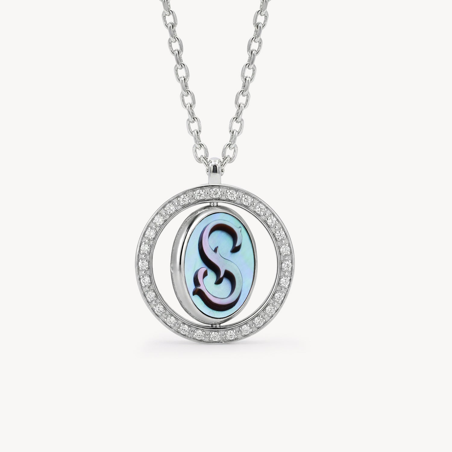 Reversible personalized initial diamond necklace with a black mother-of-pearl background, shown on a 925 sterling silver chain.