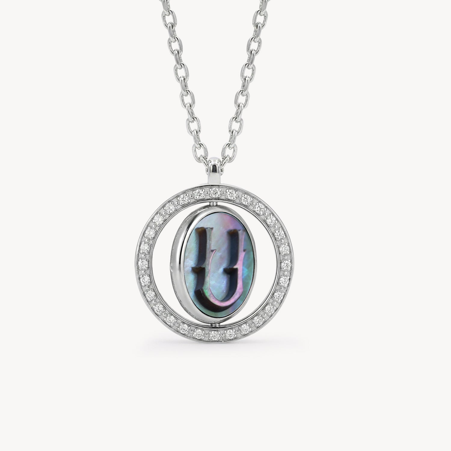 Reversible personalized initial diamond necklace with a black mother-of-pearl background, shown on a 925 sterling silver chain.