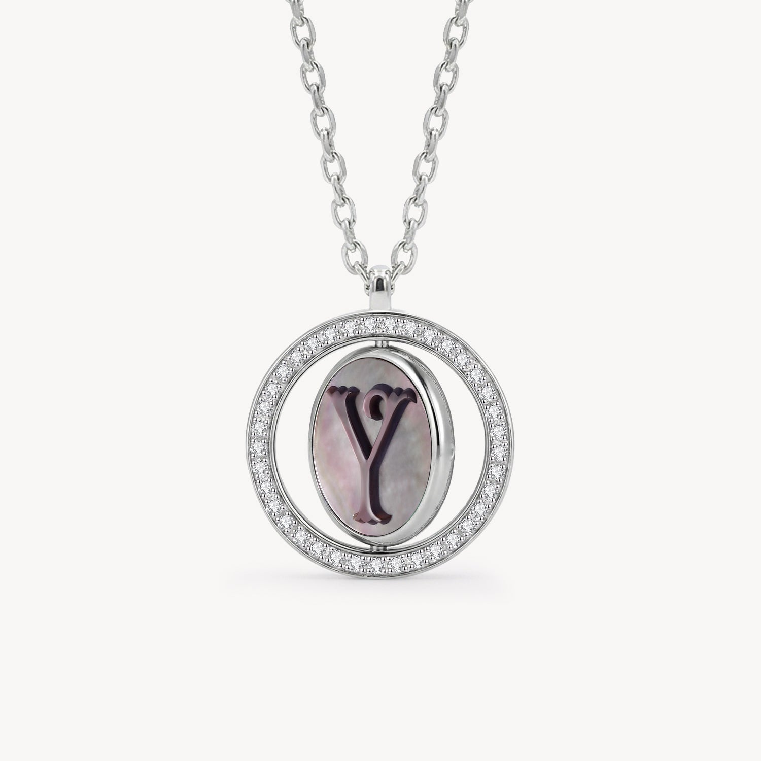 Reversible personalized initial diamond necklace with a black mother-of-pearl background, shown on a 925 sterling silver chain.